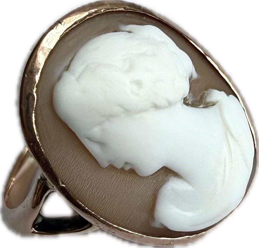 Gorgeous Signed shell cameo ring set in 9ct rose gold. The cameo is carved in relief from a shell, featuring a profile of Godess Flora.  The shell appears to be a light color, contrasting with the darker background, which enhances the details of the