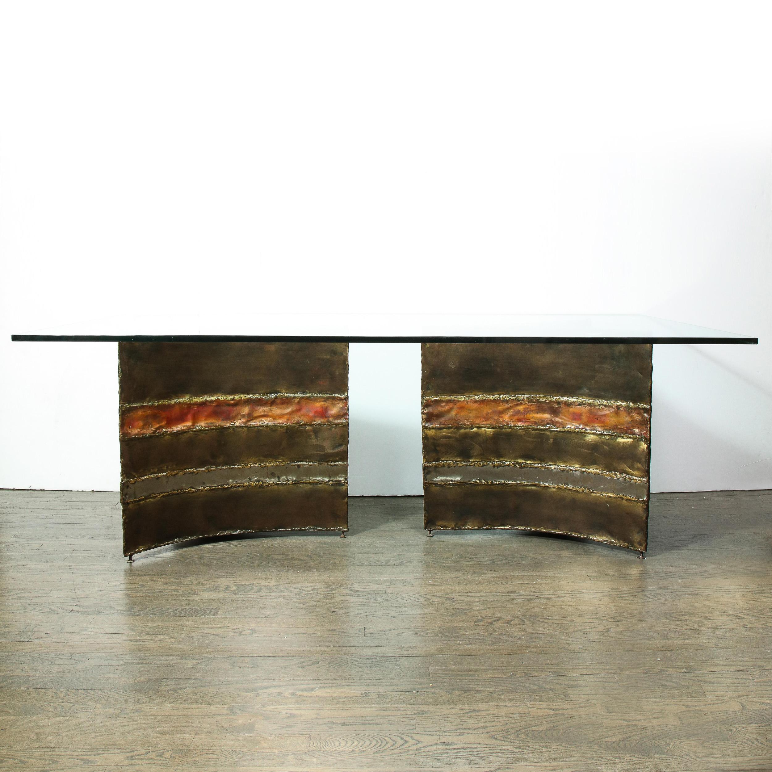 This sophisticated and rare Mid-Century Modern Brutalist dining table was created by the esteemed American designer, Silas Seandel in 1977. It features a sculptural Brutalist base consisting of two triangular shaped forms with scalloped sides with