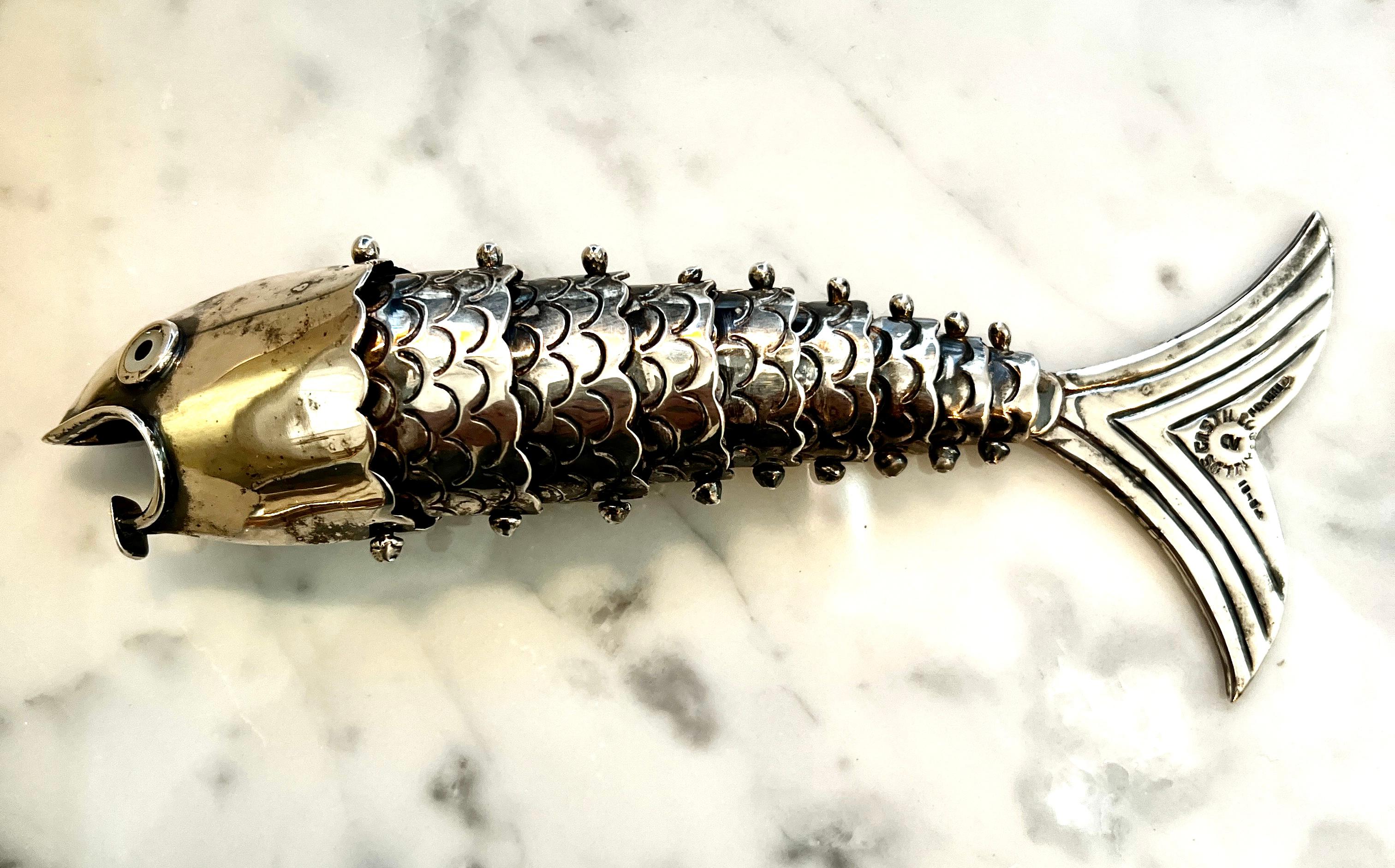 A Los Castillo Mexican Silver plated Articulated fish Bottle Opener.  

The elegance in silver plate adds a great amount of sophistication and elegance to the well designed bar and  bartender.  Los Castillo is known for their impeccable workmanship