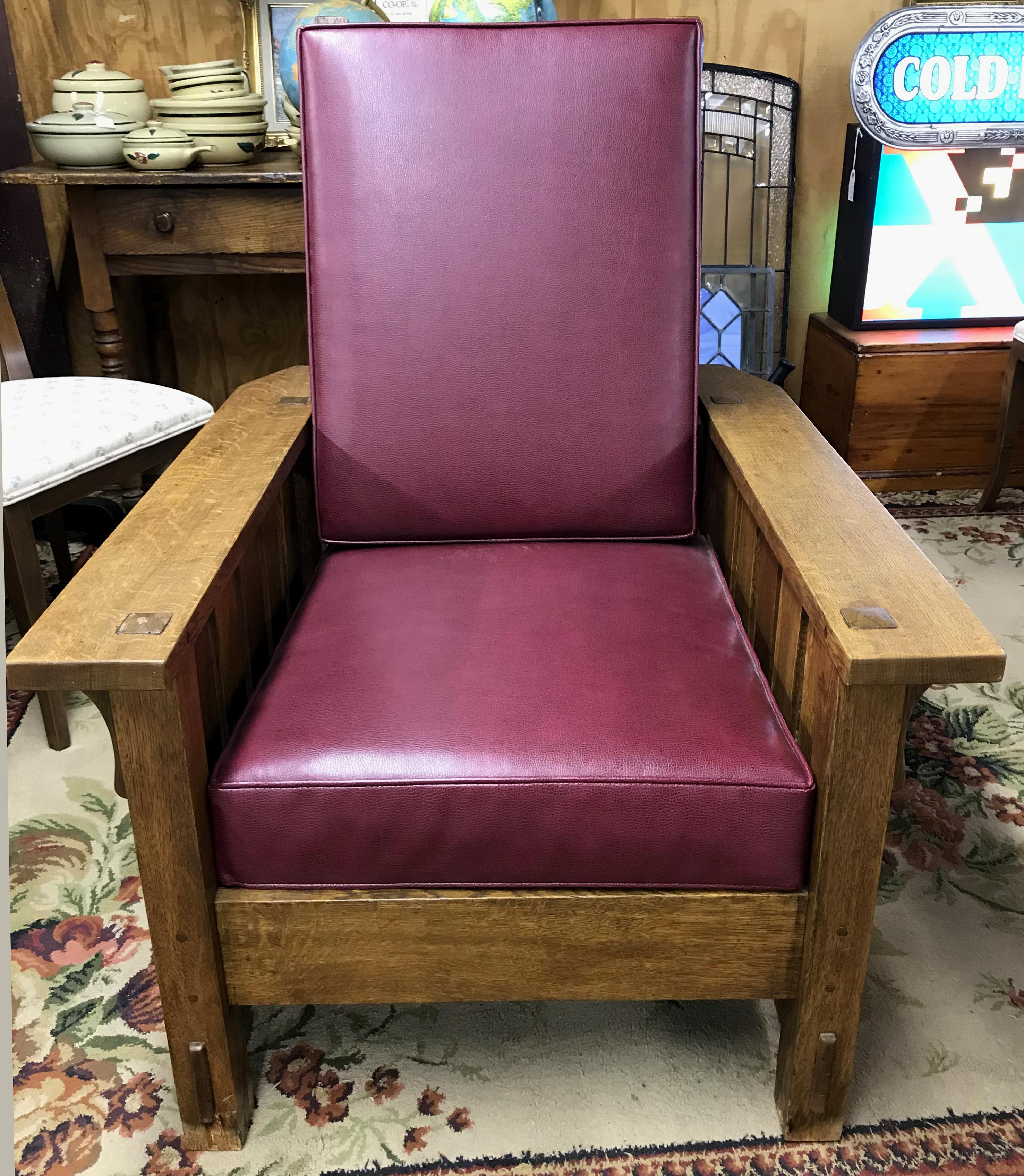 A solid oak Stickley Arts & Crafts Mission Morris chair with cranberry color leather pad upholstery and adjustable back, with the Stickley Craftsman Workshops brand, dating the piece to circa 1912-1916. Gustav Stickley shifted to a heat brand to