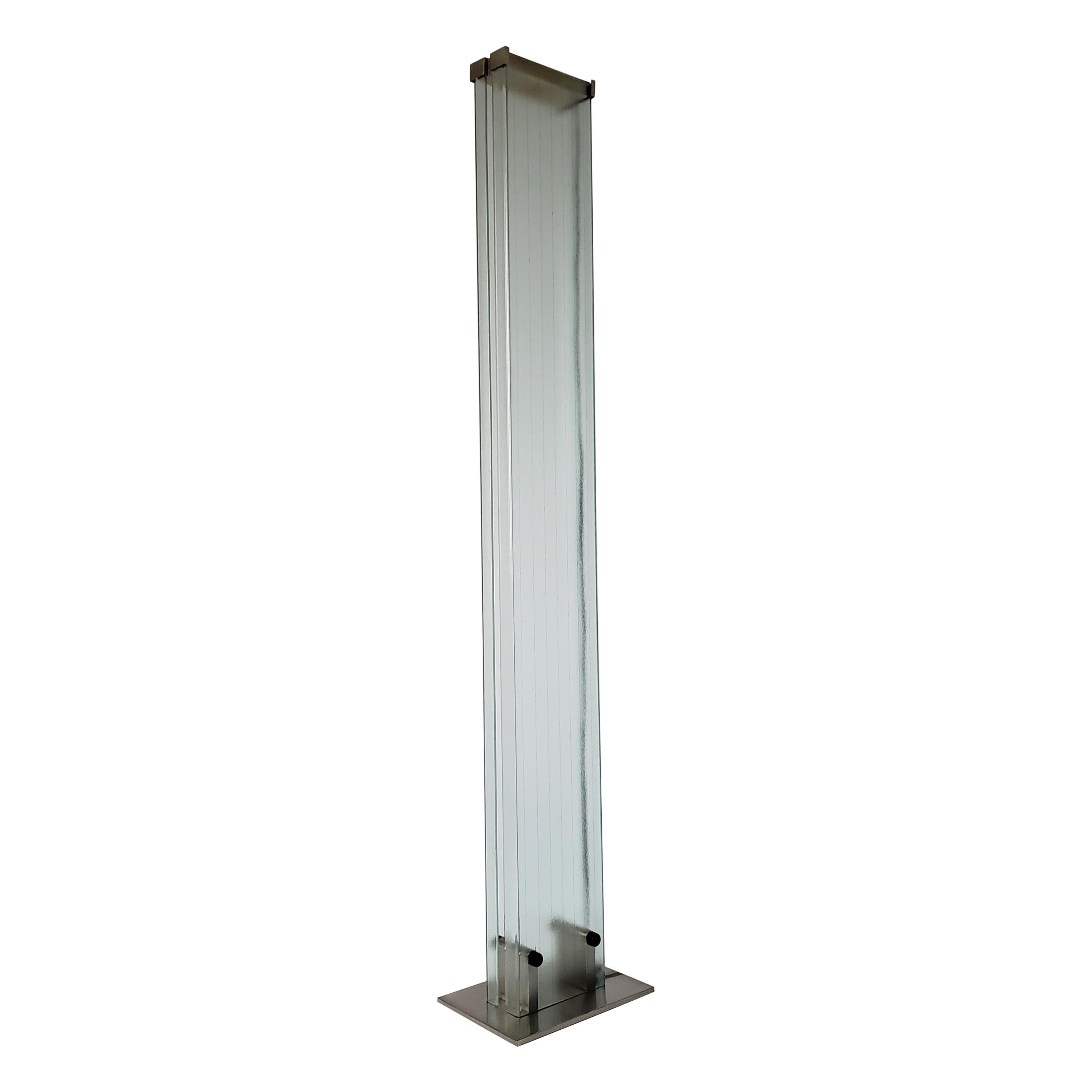 Minimalist powerfull halogen torchiere made of texturized tempered glass and lacquered stainless steel . 

Each glass piece measure 71 in. high by 9 in. wide .

Stainless steel base measure 14 in. wide by 9.5 in. deep .

Rated at 500 watt .