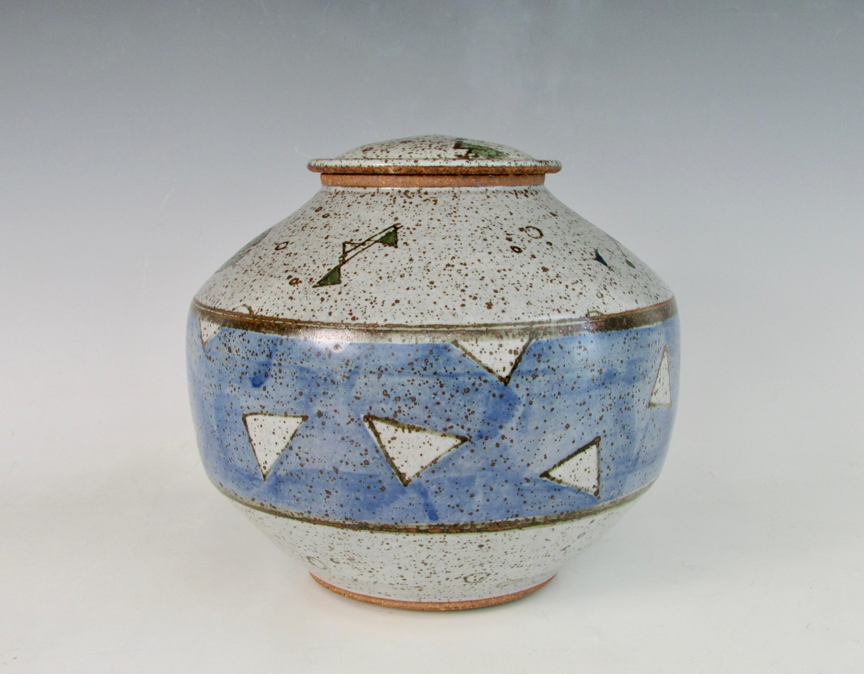 An original signed lidded stoneware vessel by Ken Thompson. I appreciate this piece for the quality craftsmanship, speckled glaze, and witty shapes. It's a wonderful blend of mid-century stoneware and postmodern fun.

Previously a self employed