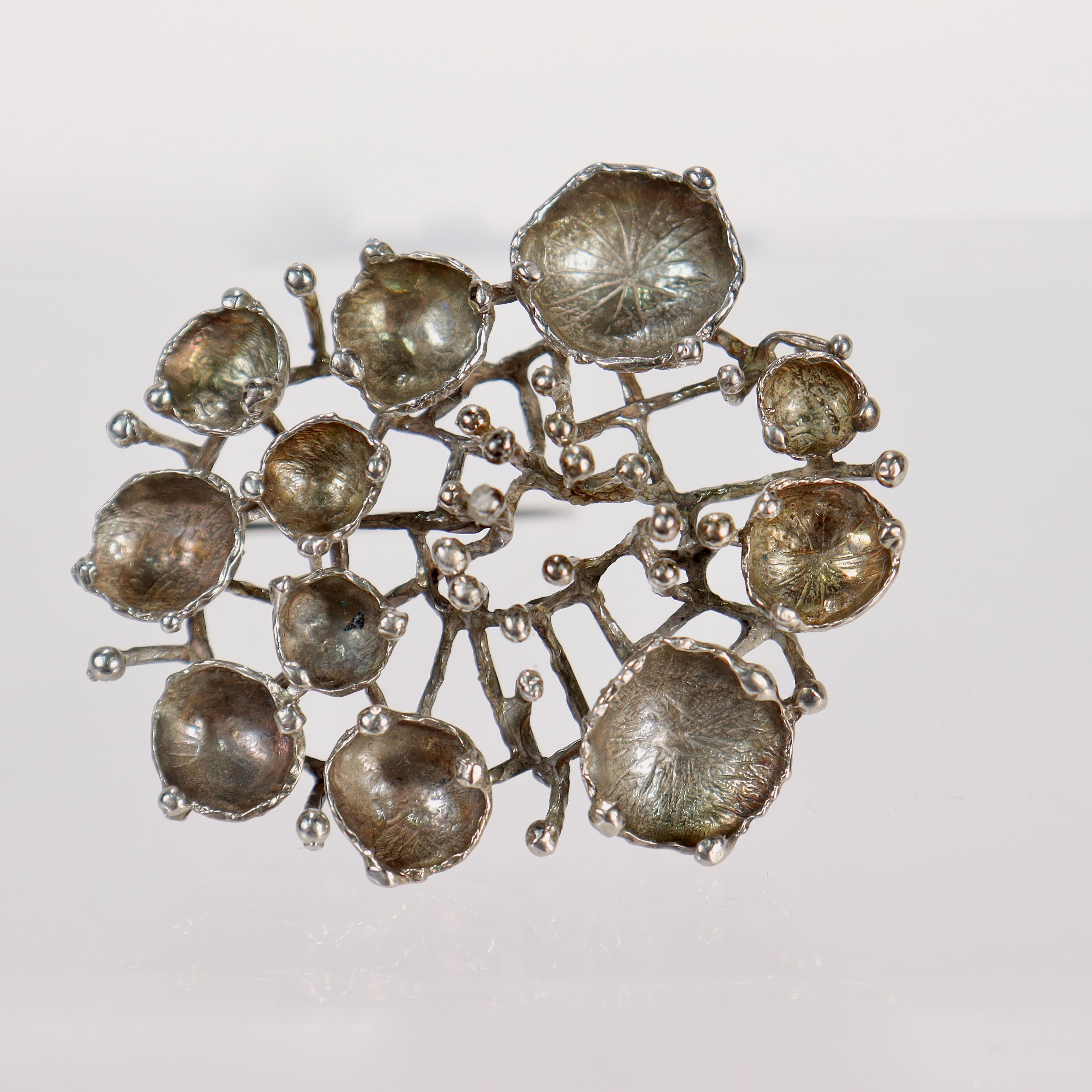 A very fine Swedish brooch 

Hand crafted and reminiscent of a sea creature. 

The bowl shapes have the feel of barnacles; while the open wire design resembles the coral reef.

Simply a beautiful modernist brooch!

Date:
20th Century

Overall