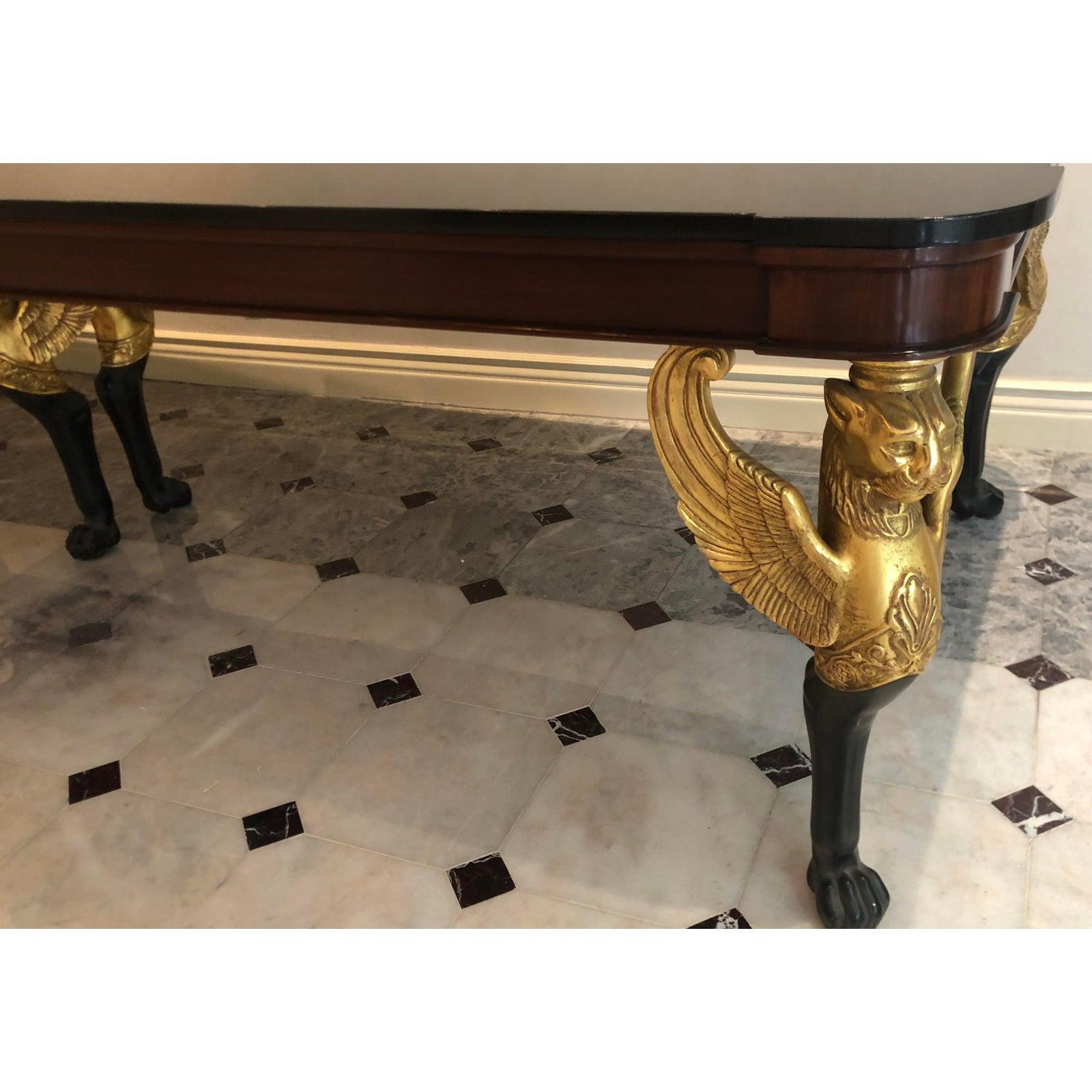 Signed Thomas Morgan 11’ Empire dining or conference table W Winged Griffins. Features hand carved and gilded details including winged griffin legs and three-piece granite top.
