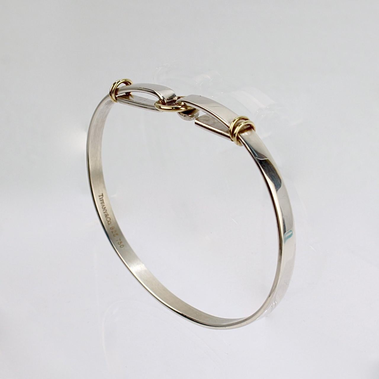 A fine Tiffany & Co. bracelet.

In sterling silver and 18 karat gold.

With a hook and circle closure.

Together with its original Tiffany box.

Simply great Tiffany design!

Date:
20th Century

Overall Condition:
It is in overall good, as-pictured,