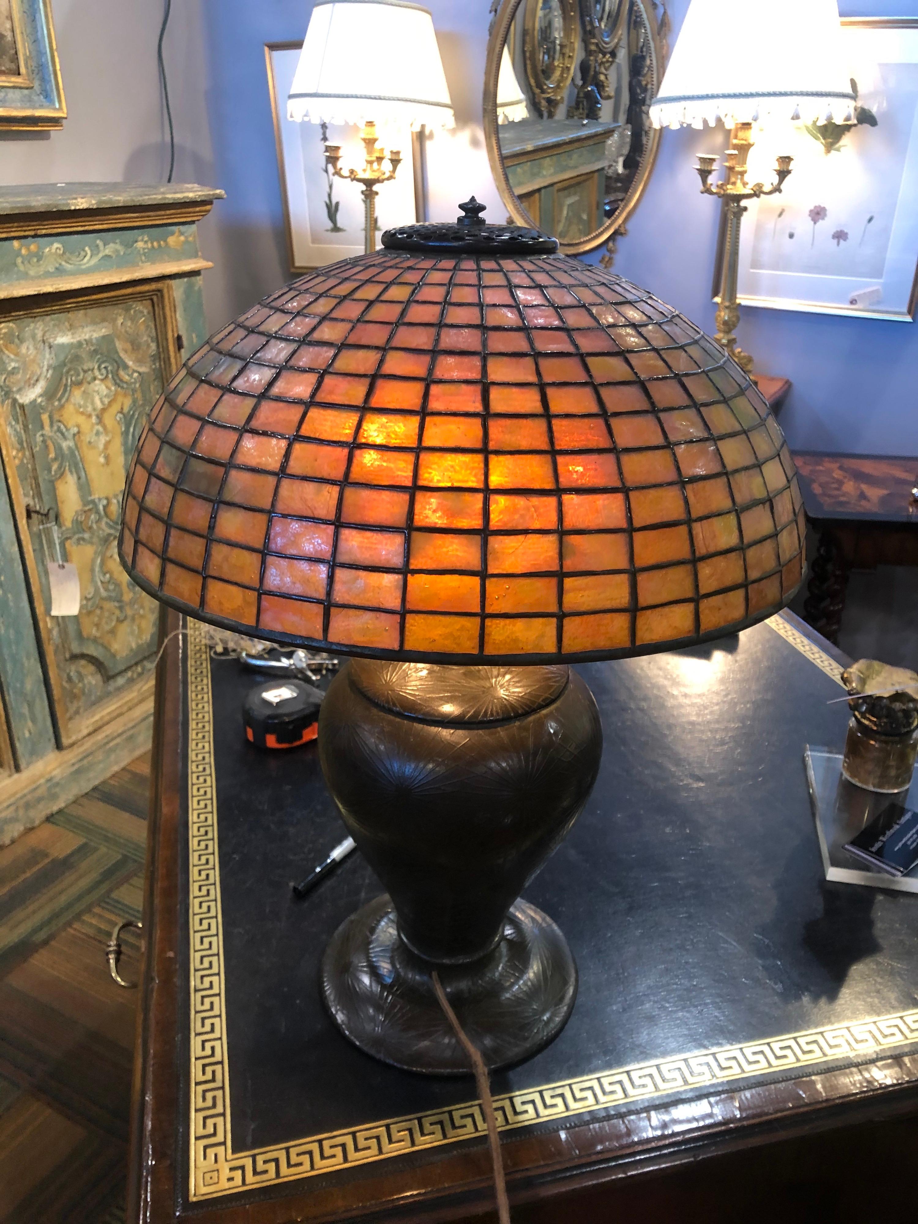 Signed Tiffany & Co. lamp- pine needle base with an intact amber colored geometric shade. Stamped “Tiffany Studios New York 1436” on a pine needle base stamped “D443 19”.