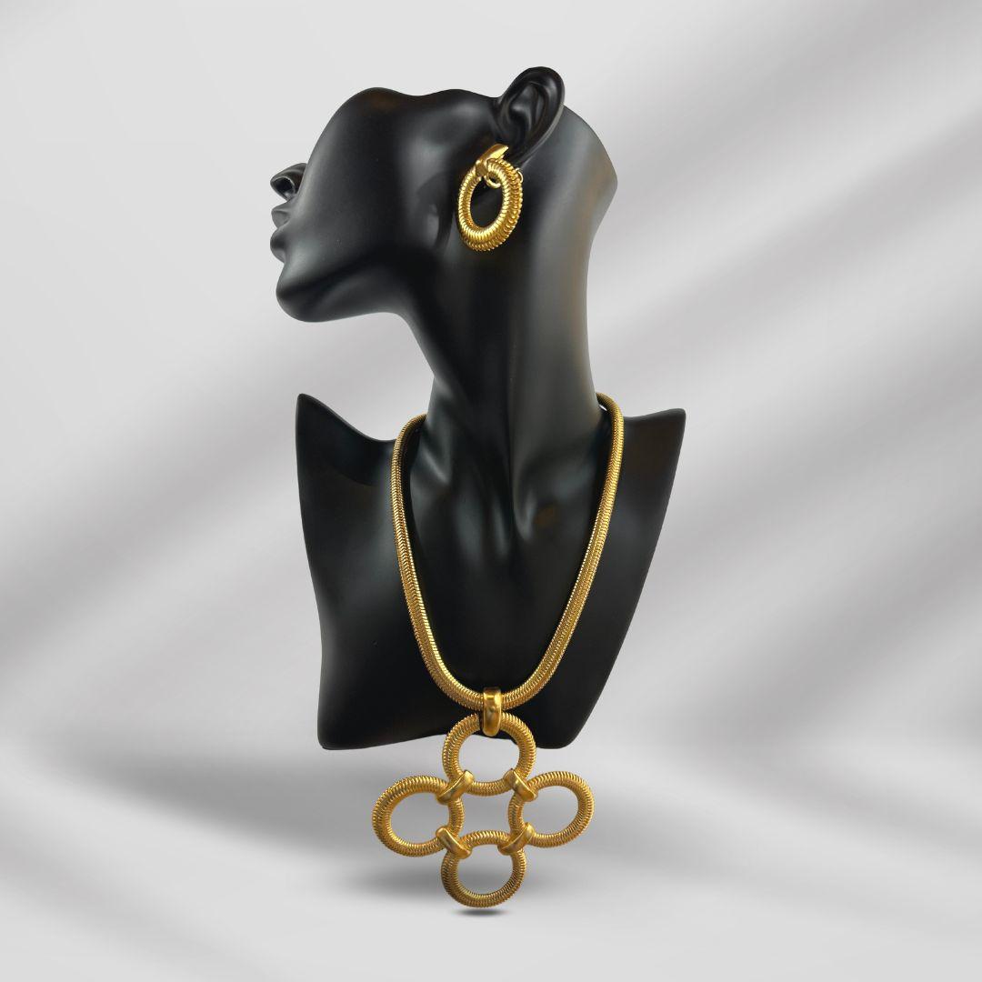 Pendant Width:3.30″

Pendant Hight:3.30″

Earrings Diameter:1.25″

Bin Code: A5 / P7

Experience the timeless elegance of this Vintage Trifari Set of Gold Color Necklace & Earrings. Crafted by the renowned Trifari brand, this exquisite jewelry set