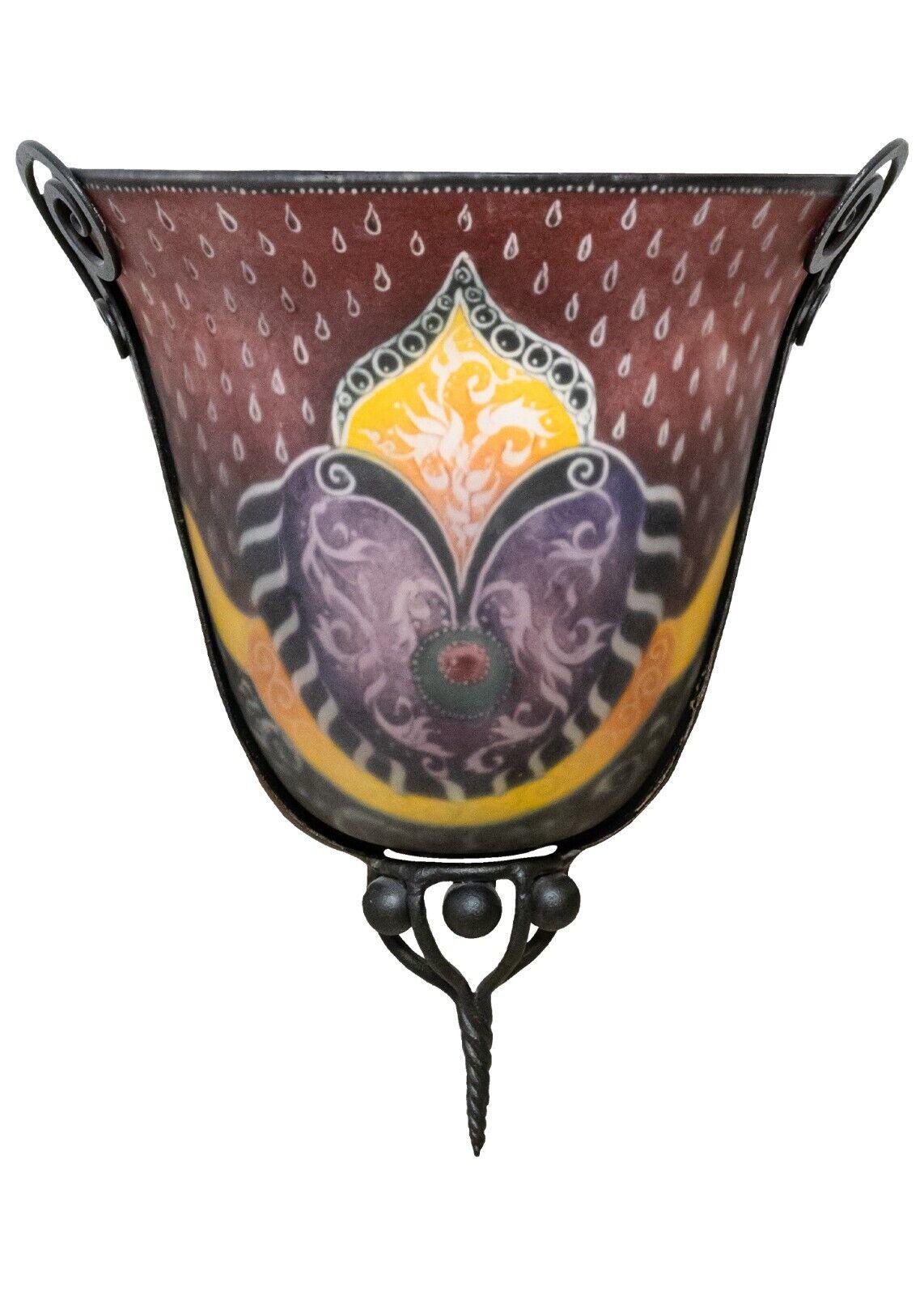 An Ulla Darni painted glass sconce. This beautifully crafted lighting fixture will catch the eye of anyone who passes. It consists of a two part construction; the painted glass and the metal frame. The glass has a frosted appearance that looks soft