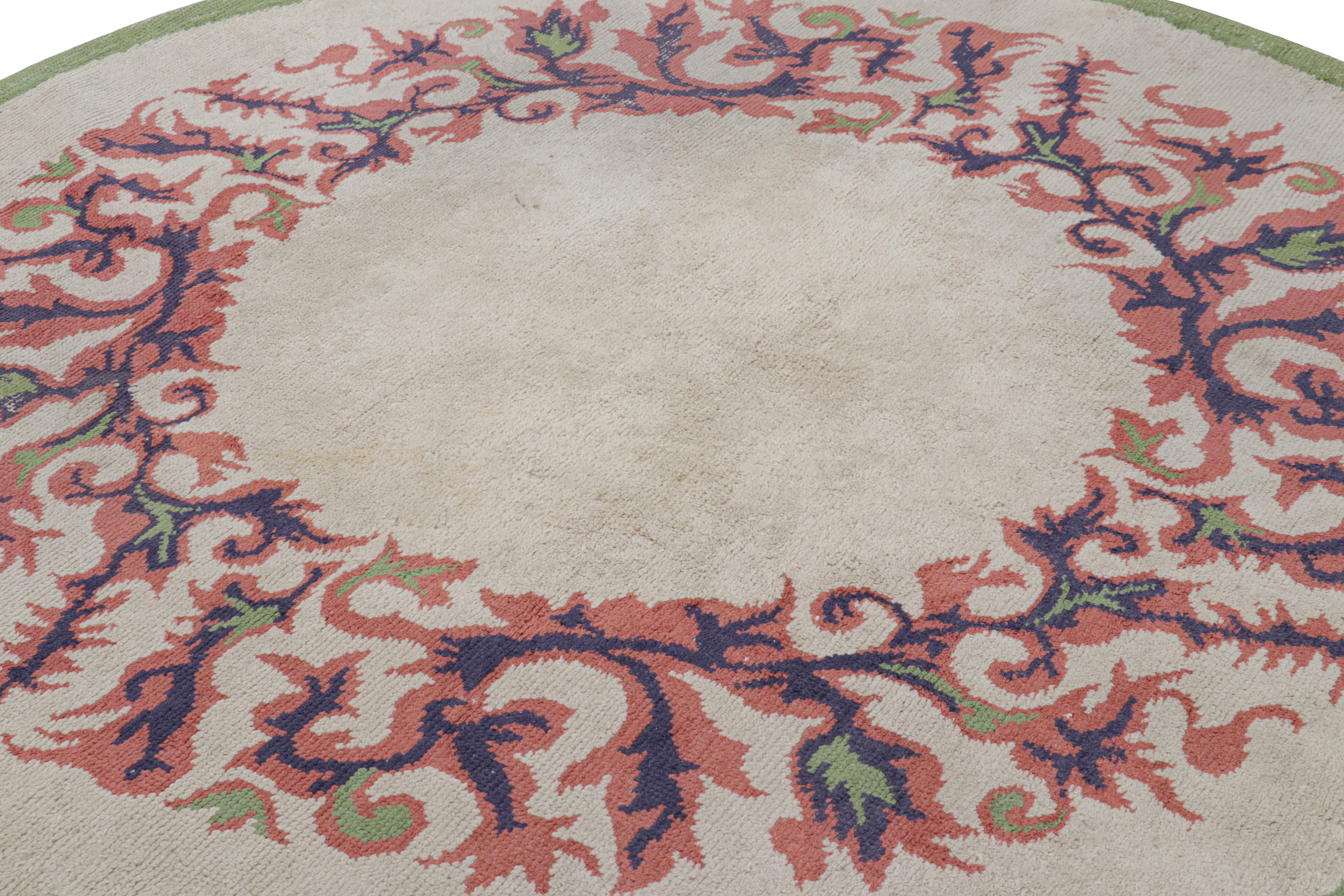 Made with hand-knotted wool in France circa 1940-1950, this 7x7 vintage French Art Deco rug is an extremely collectible mid-century circle rug from Leleu Decorateur—the work of an iconic family label known for their impact on an iconic design