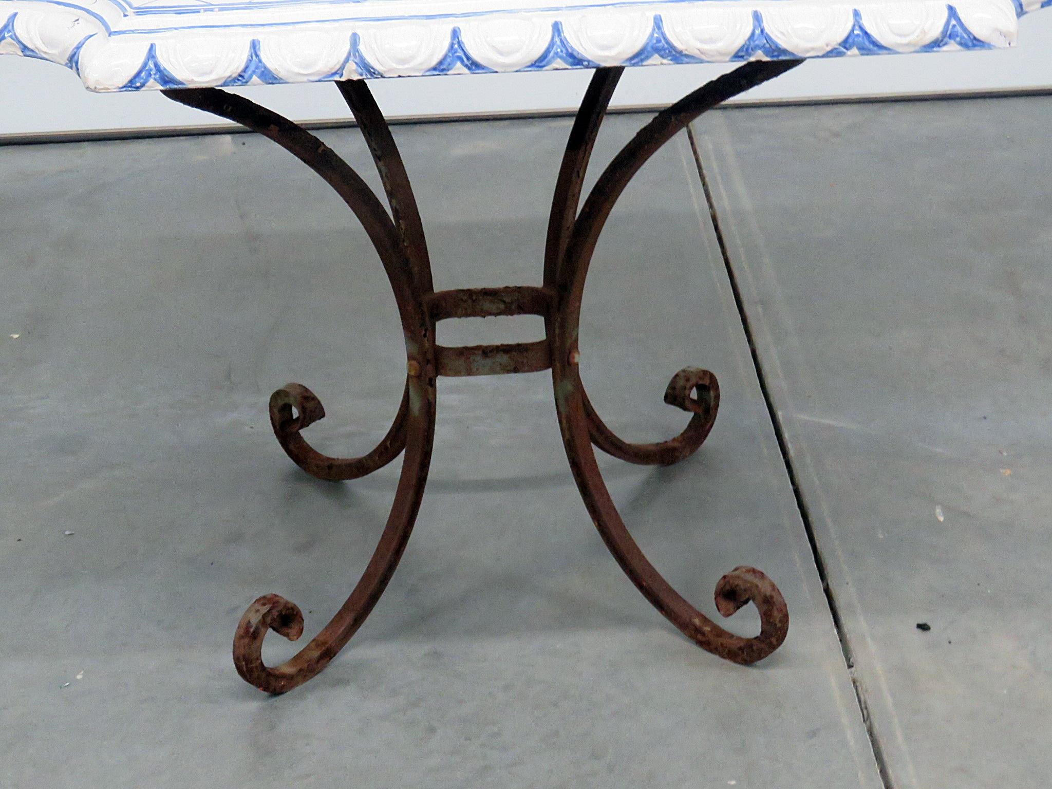 Signed vintage porcelain top center table with a wrought iron base.
