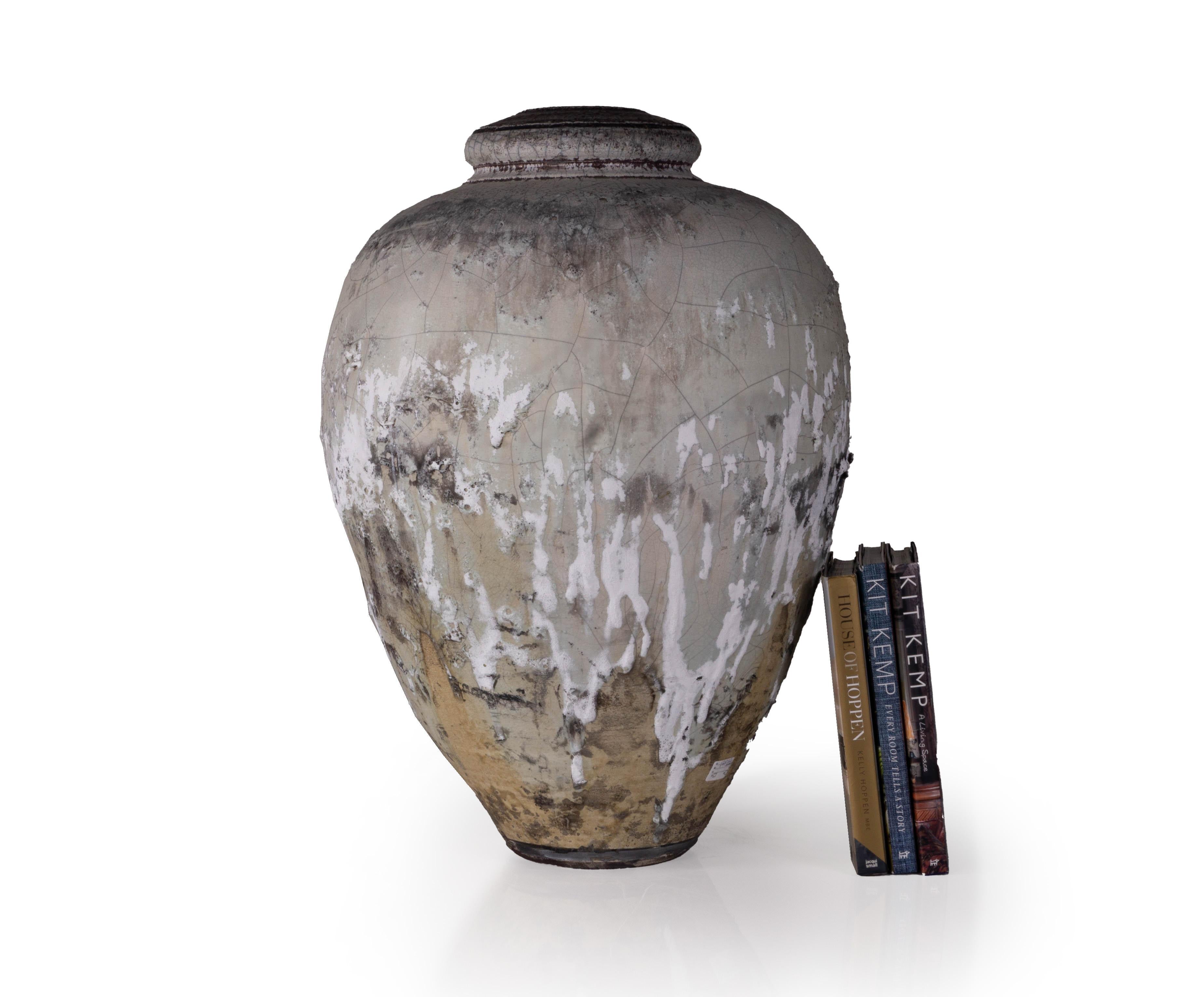 This large vintage raku fired studio pottery vase is a spectacular addition to any contemporary or mid-century modern home. This piece beautifully reflects traditional raku style pottery in which clay is removed from the kiln at the height of firing
