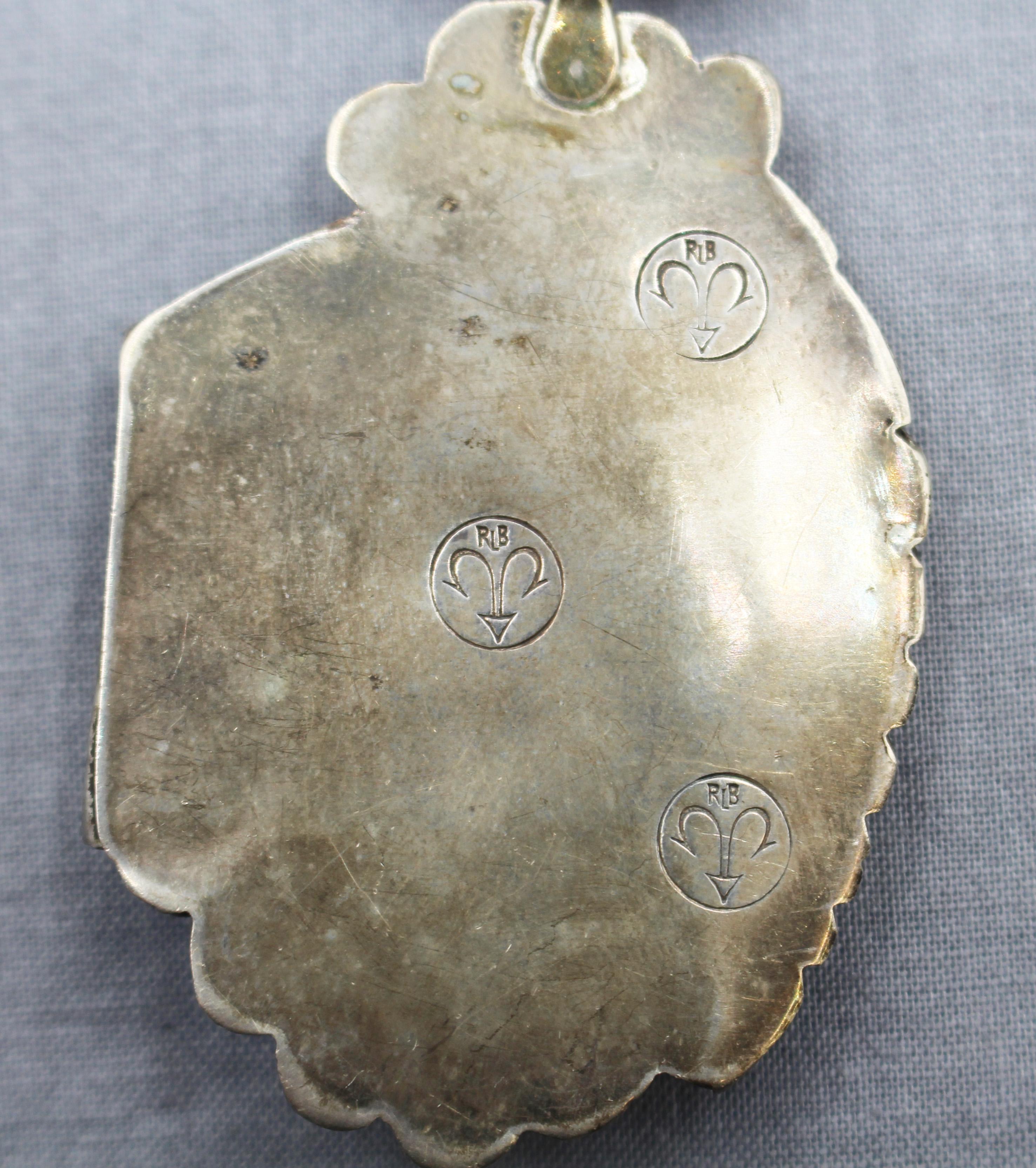 Signed set of Zuni turqouise & sterling jewelry, vintage. Necklace, bracelet, ring & clip earrings. All pieces have one or more hallmarks, RLB in a fish-hook cartouche. Desk & Dresser in Bozeman, MT has a well researched pendant with these marks and