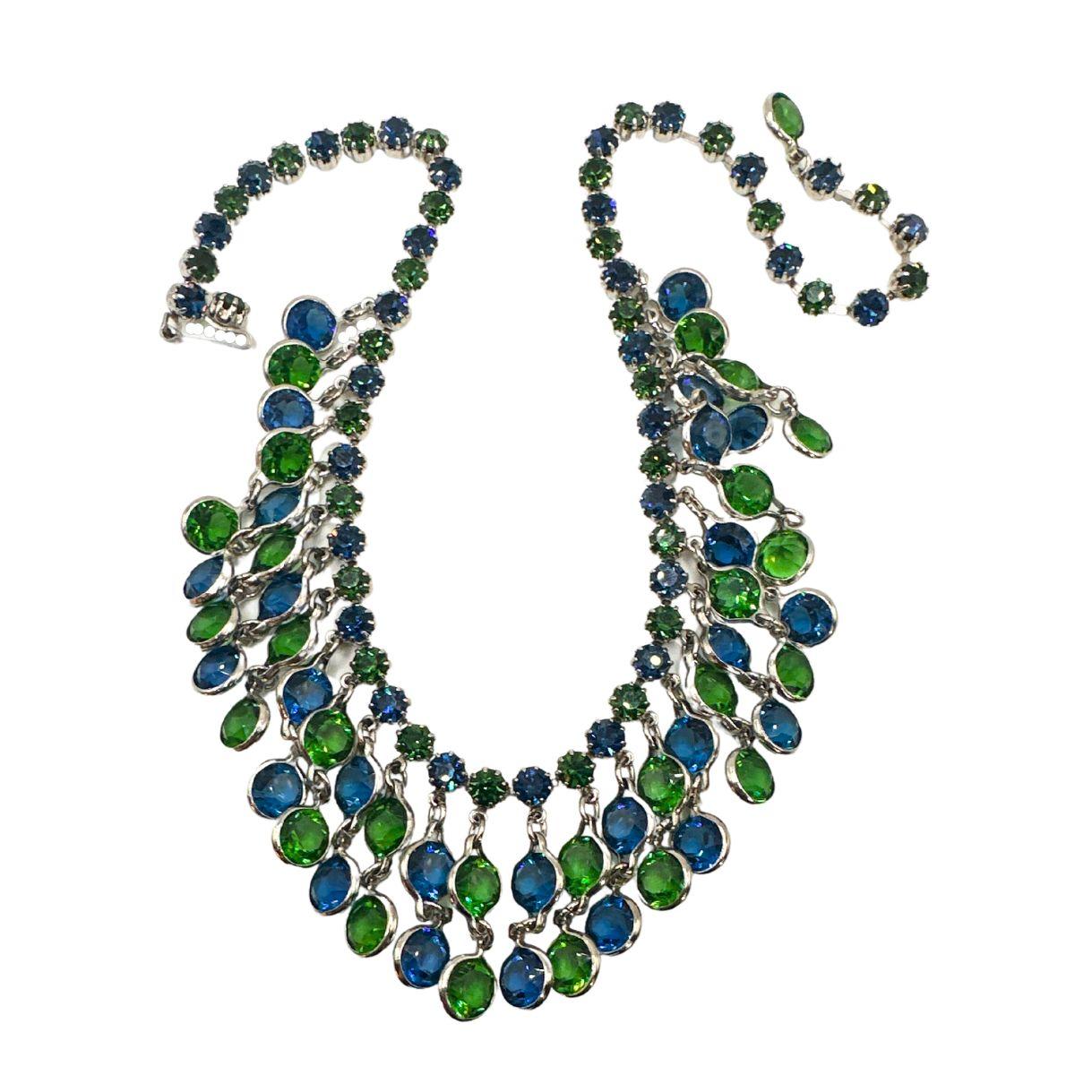 Necklace Length: 17″:

Bin Code: N12 /P13

Add a touch of vintage charm to your ensemble with this exquisite Weiss Vintage Blue and Green Glass Multi-Drops Charm Necklace and Earrings Set. Crafted with meticulous attention to detail, this set