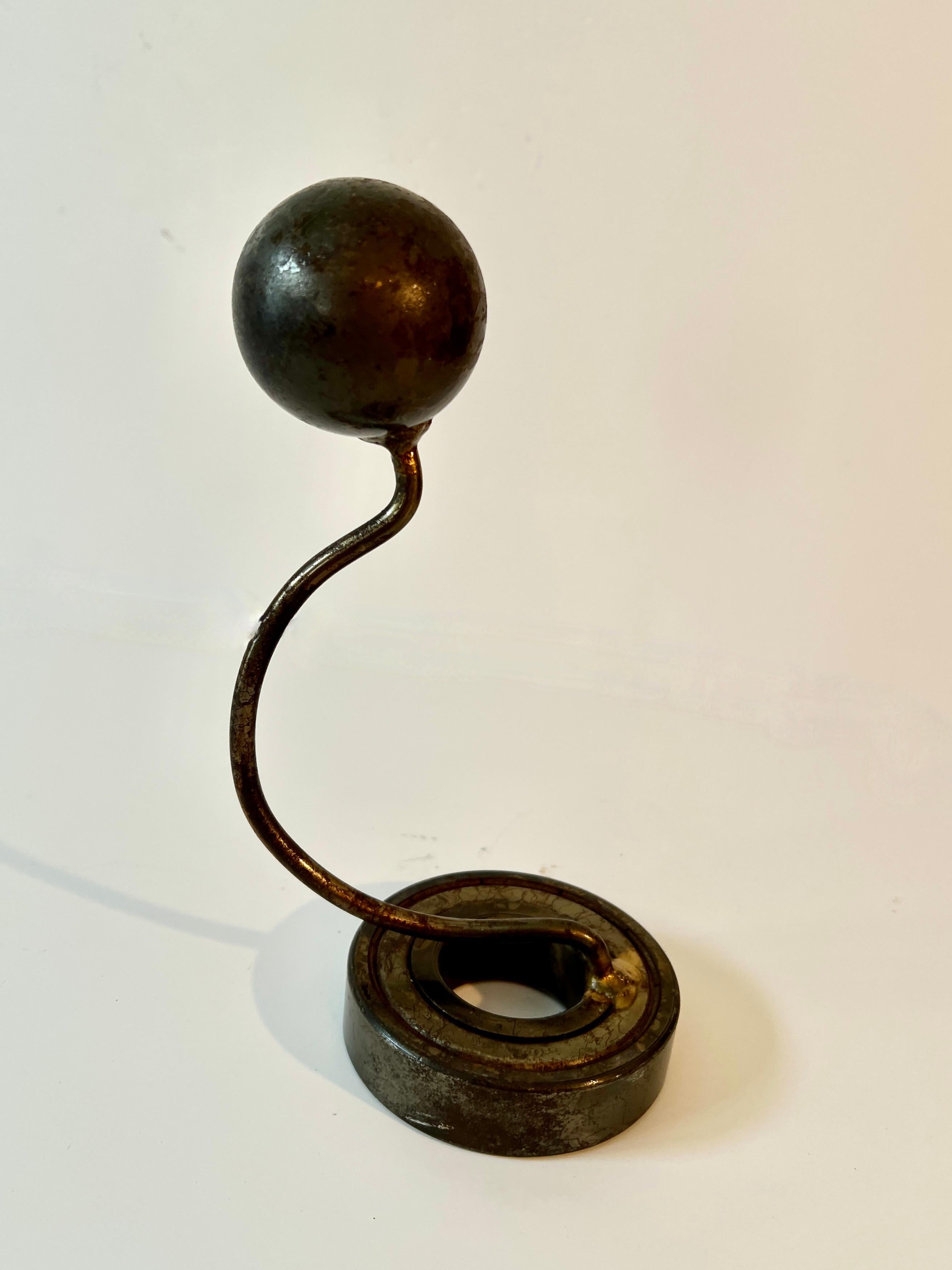 Unique Welded Iron Sculpture.  The piece is unique in that it looks like it could serve a purpose, like a hat stand?  However, the piece looks great as a stand alone piece of art and also marries well with other pieces of unique art.

The date is