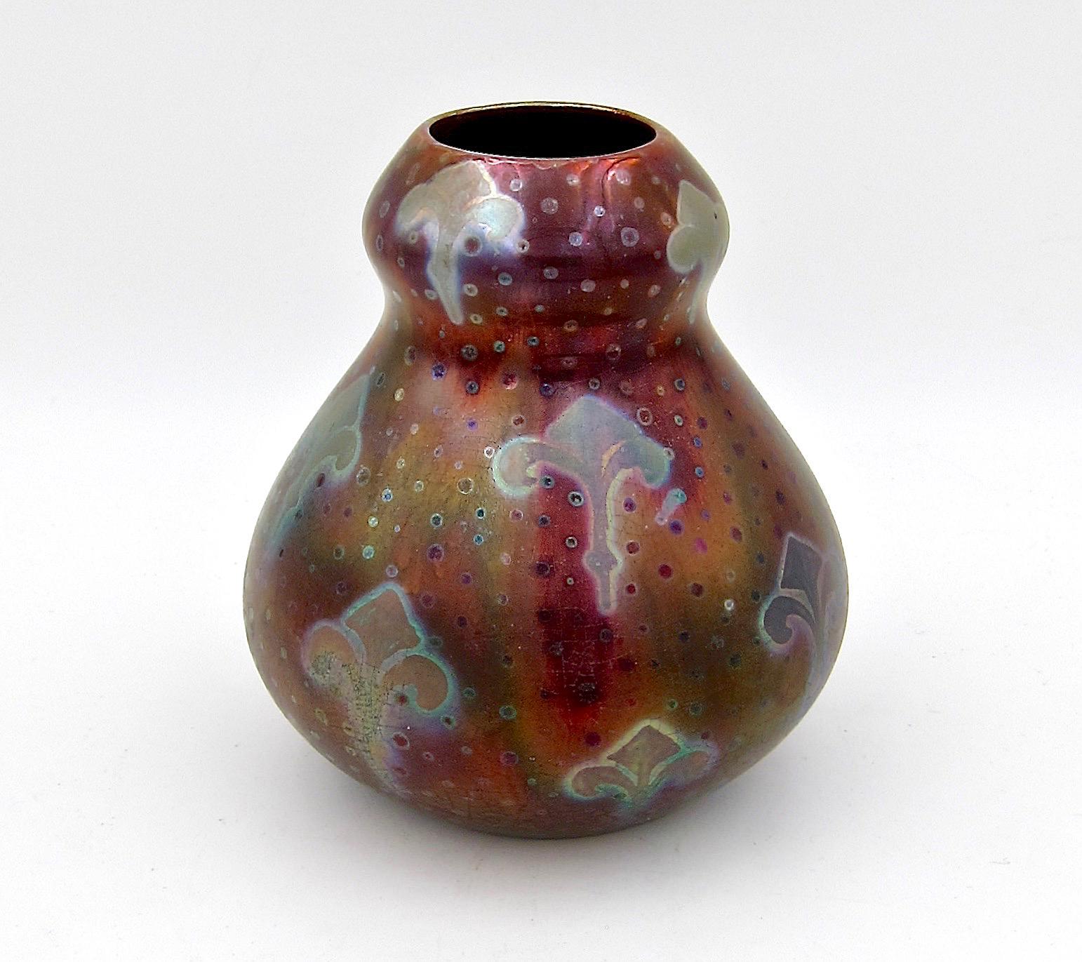 A signed American art pottery vase designed by French ceramicist Jacques Sicard (1865–1923) for Weller Pottery of Zanesville, Ohio, between 1901 and 1907. 

The antique earthenware vase is a double gourd form decorated by hand with iridescent dots