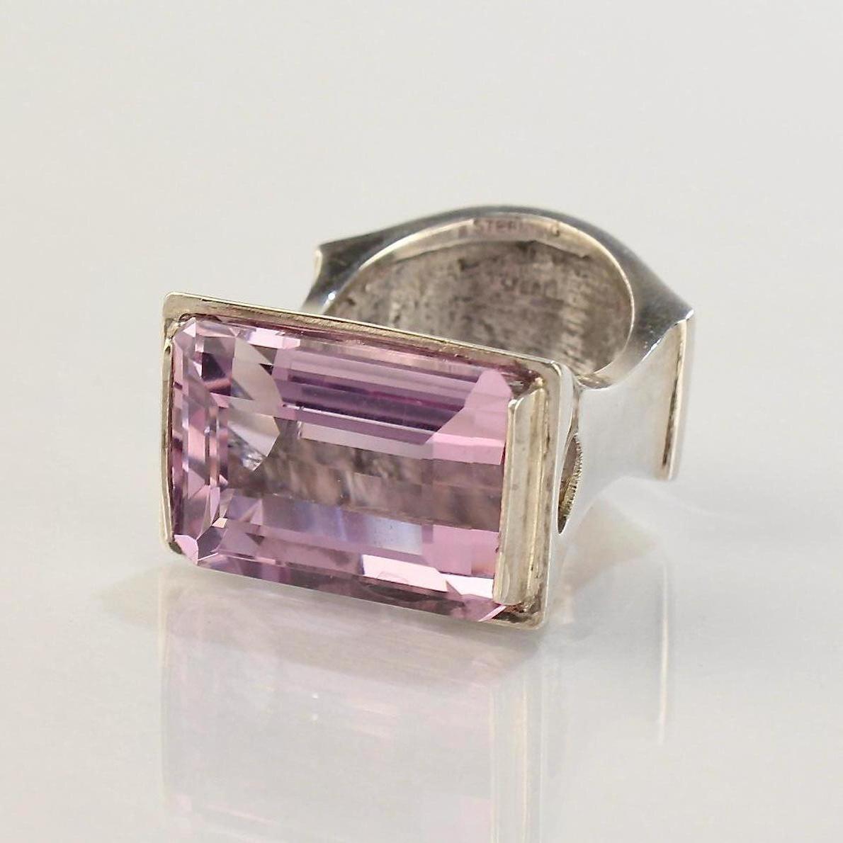 An impressive, signed Wesley Emmons ring.

Emmons was an important jewelry maker in Philadelphia during the middle of the 20th century. He created cutting-edge jewelry for decades, and his long client list included numerous prominent clients such as