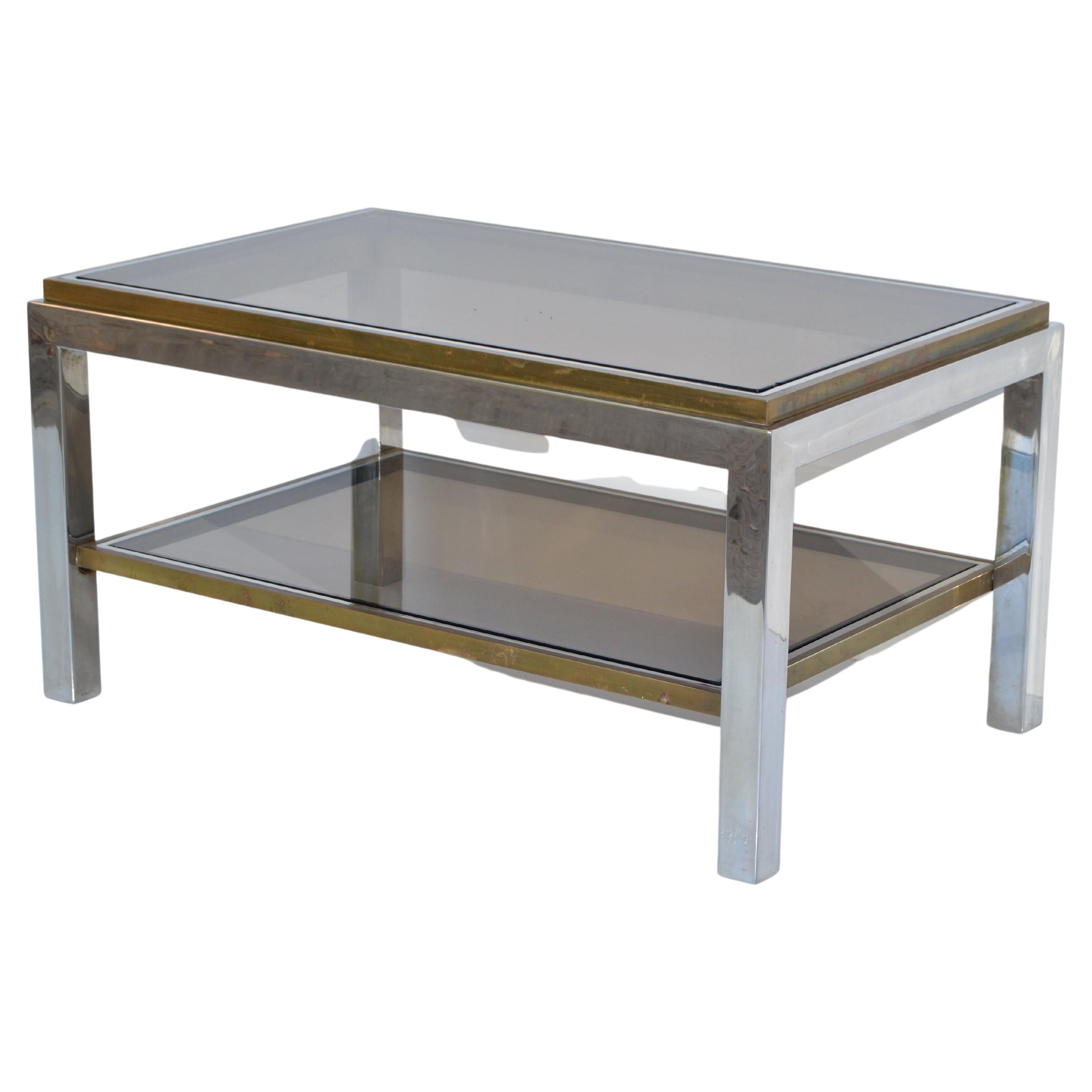 Very elegant two-tier coffee table signed Willy Rizzo made in Italy, circa 1965.
Sturdy chrome frame with brass inlay and smoked glass tops.
Space in between the glass is 7.5 inches.
Engraved Signature at the Leg: Willy Rizzo.
Mid-Century Modern