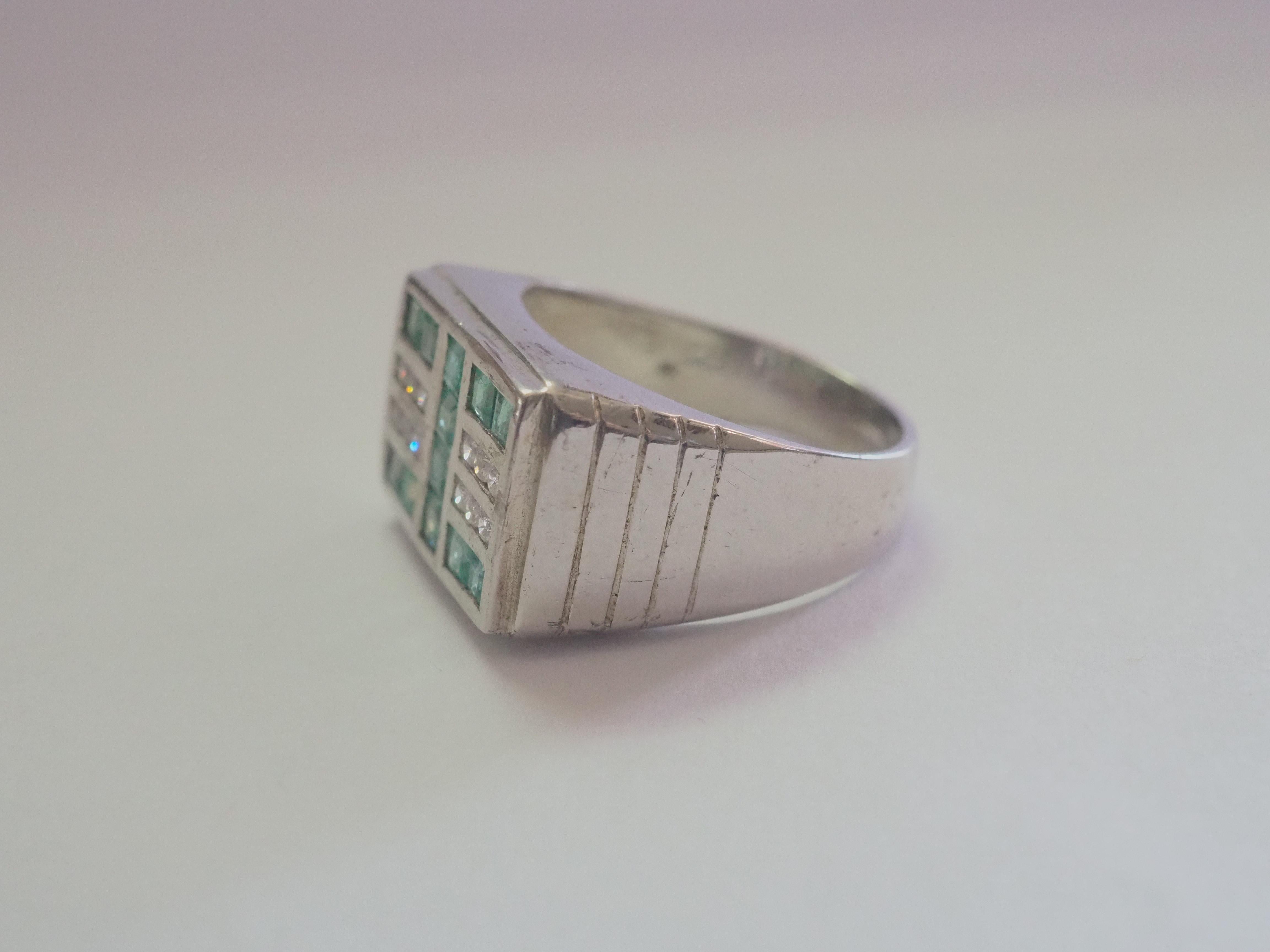 This ring is a Stunning men's band ring in solid sterling silver. The ring is decorated by natural and decent squared emeralds inlaid beautifully. The white stones are on each end are Cubic Zirconia. The emerald gemstone is one of the most popular