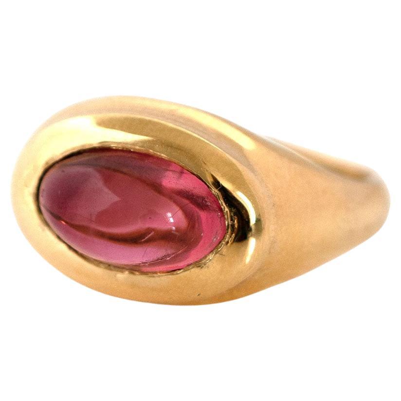Discover our Signet 18ct Gold Cabochon Tourmaline Ring, handcrafted by Master Goldsmiths in London. Featuring a captivating high cabochon pink tourmaline weighing 3.42ct. The smooth, polished cabochon cut enhances the gemstone's natural beauty and