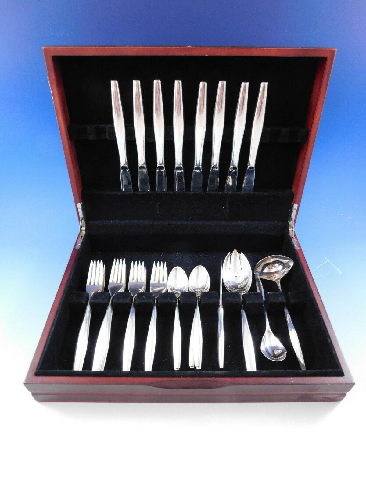 Mid-Century Modern Signet by Kirk sterling silver flatware set, 55 pieces. This unadorned pattern with modern, elongated handles was introduced by Kirk in the year 1958. This set includes:

8 knives, 9
