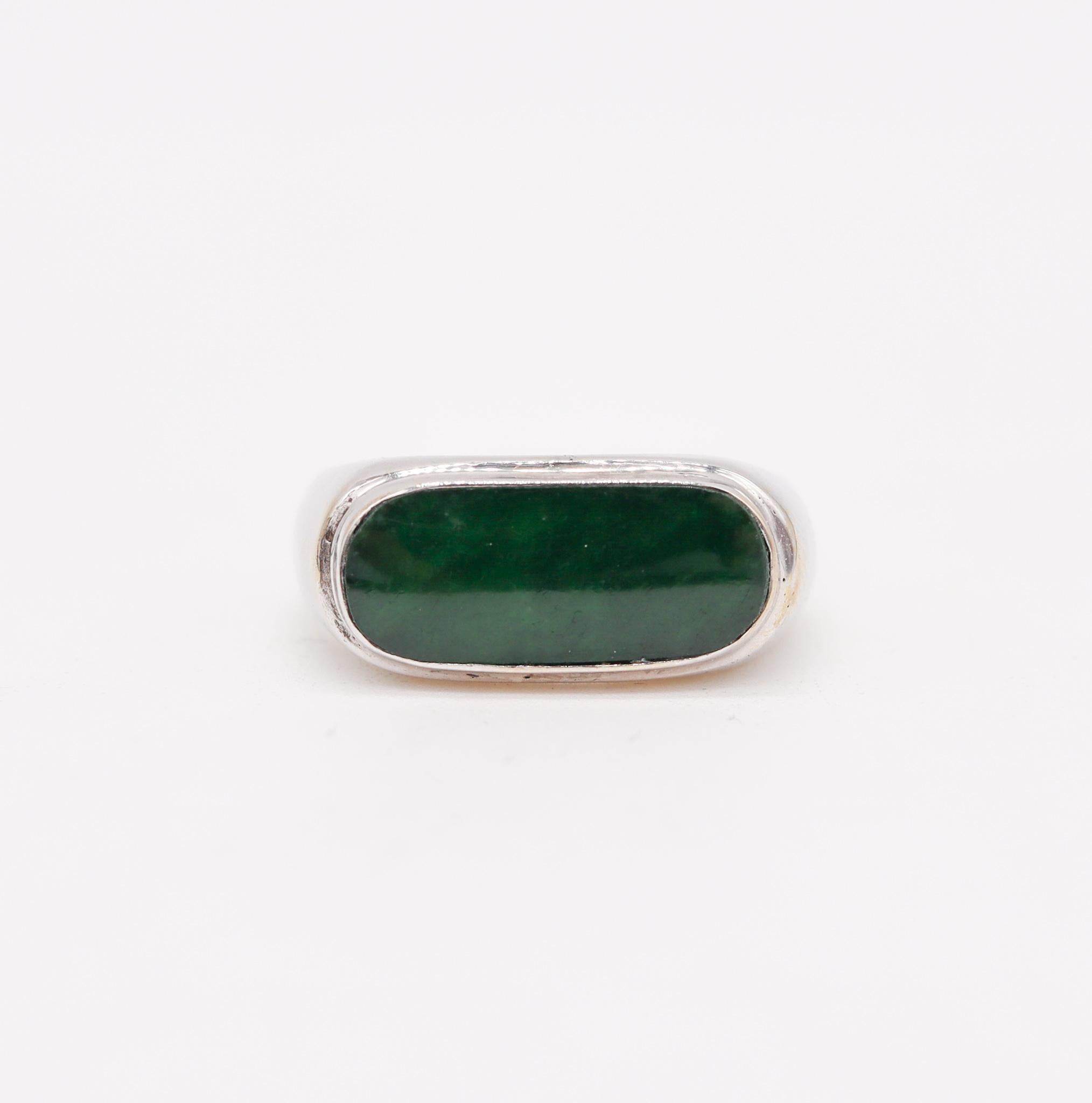 Contemporary signet ring with imperial jade.

Beautiful sleek and elegant ring crafted in solid white gold of 18 karats with high polished finish. It is mounted inside a bezel setting with one fancy cabochon cut (2 x 14 x 6 mm) of a natural imperial
