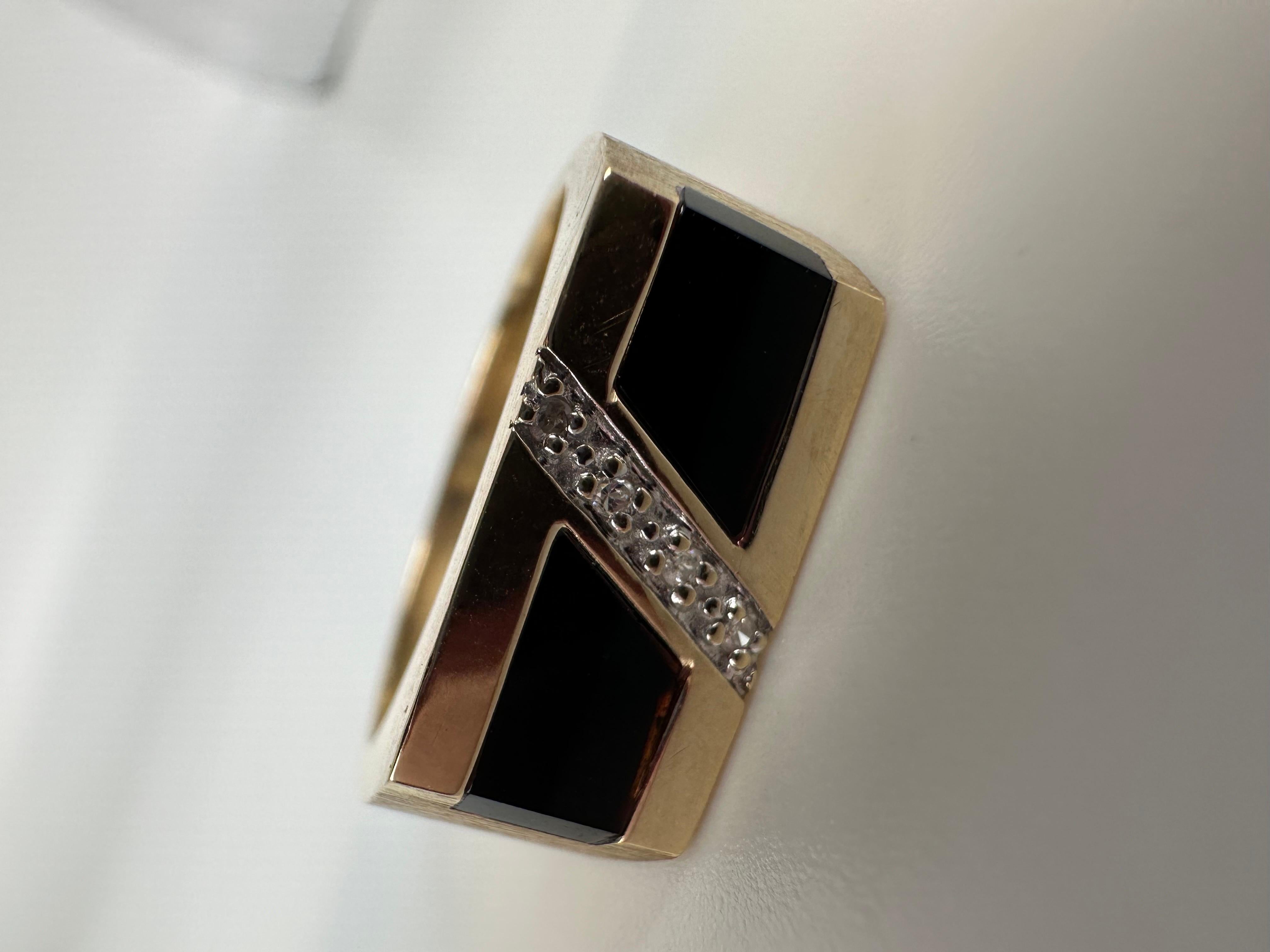 Signet unisex diamond onyx ring made in 10kt yellow gold, interestingly made with abrasive texture on the band.

GOLD: 10KT gold
NATURAL DIAMOND(S)
Clarity/Color: SI/G
Carat:0.02ct
Cut:Round
Grams:4.91
size: 8.5
Item#: 200-00067MKA

WHAT YOU GET AT