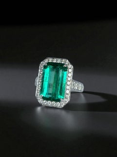 Significant Emerald Solitaire (Emerald Cut) and brilliant cut diamond ring