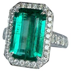Significant Emerald Solitaire (Emerald Cut) and brilliant cut diamond ring