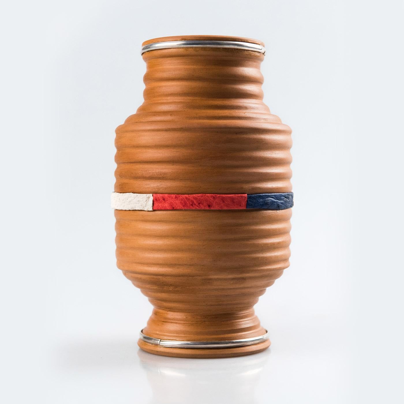 A sublime display of traditional craftsmanship, this stunning vase is deftly handmade of first-rate materials using time-old techniques from the Italian artisanal tradition. Its sturdy and elegant silhouette is outlined by a series of concentric