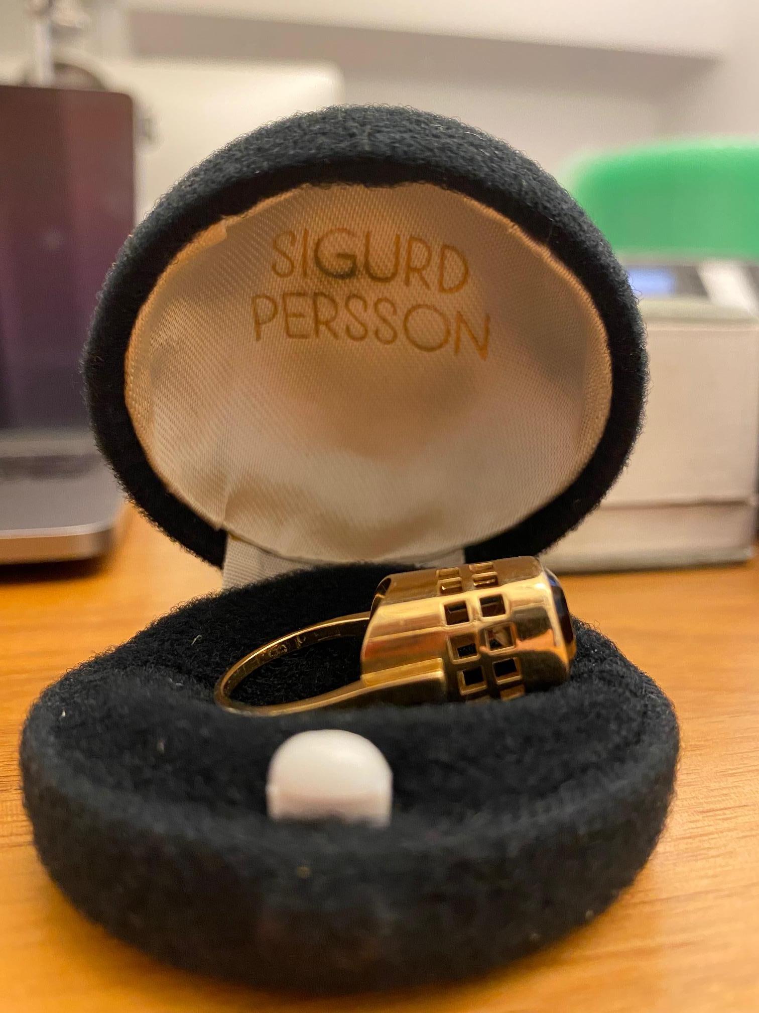 A smoky quartz and 18 karat gold ring, designed with height and cutouts in gold, to fully showcase the stone, by Sweden's most important and versatile designer Sigurd Persson (1914 - 2003). 

Stamped with maker's mark, Swedish hallmarks. This highly