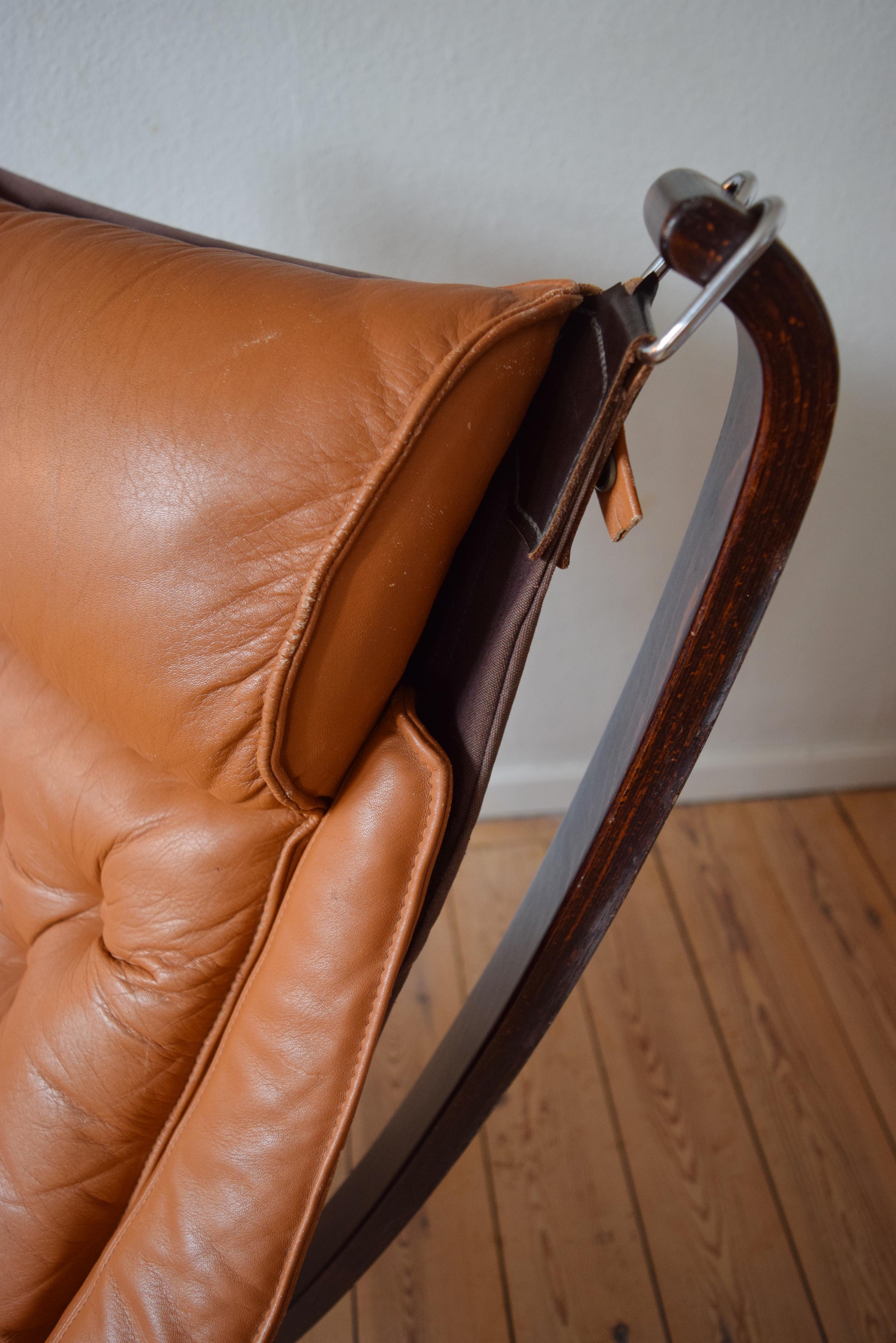 Winged falcon chair designed by Sigurd Ressel and manufactured by Vatne Møbler in Norway in the 1970s. Features cognac leather cushion and sits on a canvas hammock. The leather is in great shape and is still soft and supple. Stamped on the frame by