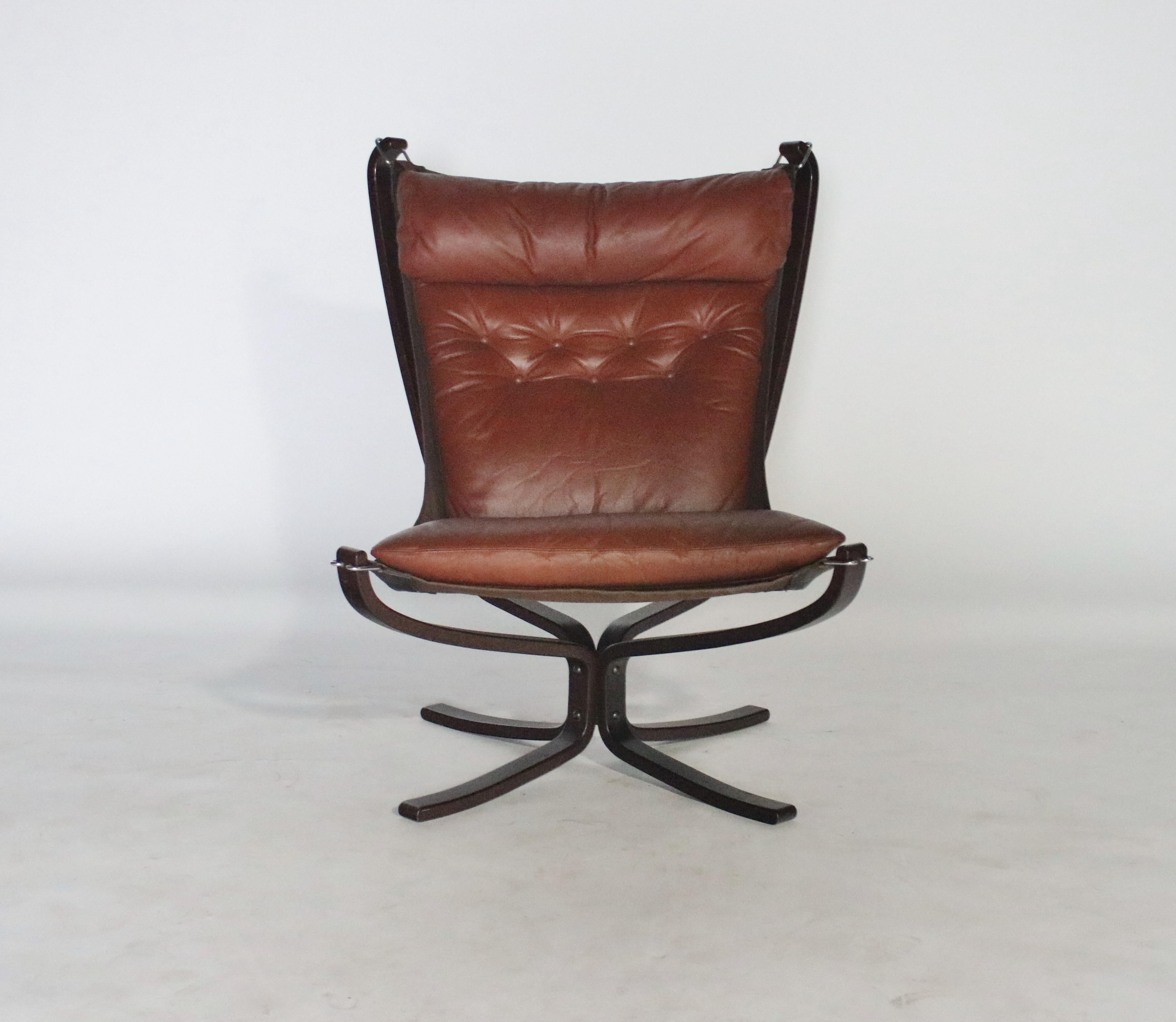 Brown leather Falcon chair designed by Sigurd Ressel for Vatne Mobler, 1970s. All original chair in very good condition with reconditioned brown leather and all tufting in tact. A canvas hammock-style canvas sling hangs from the stained beechwood