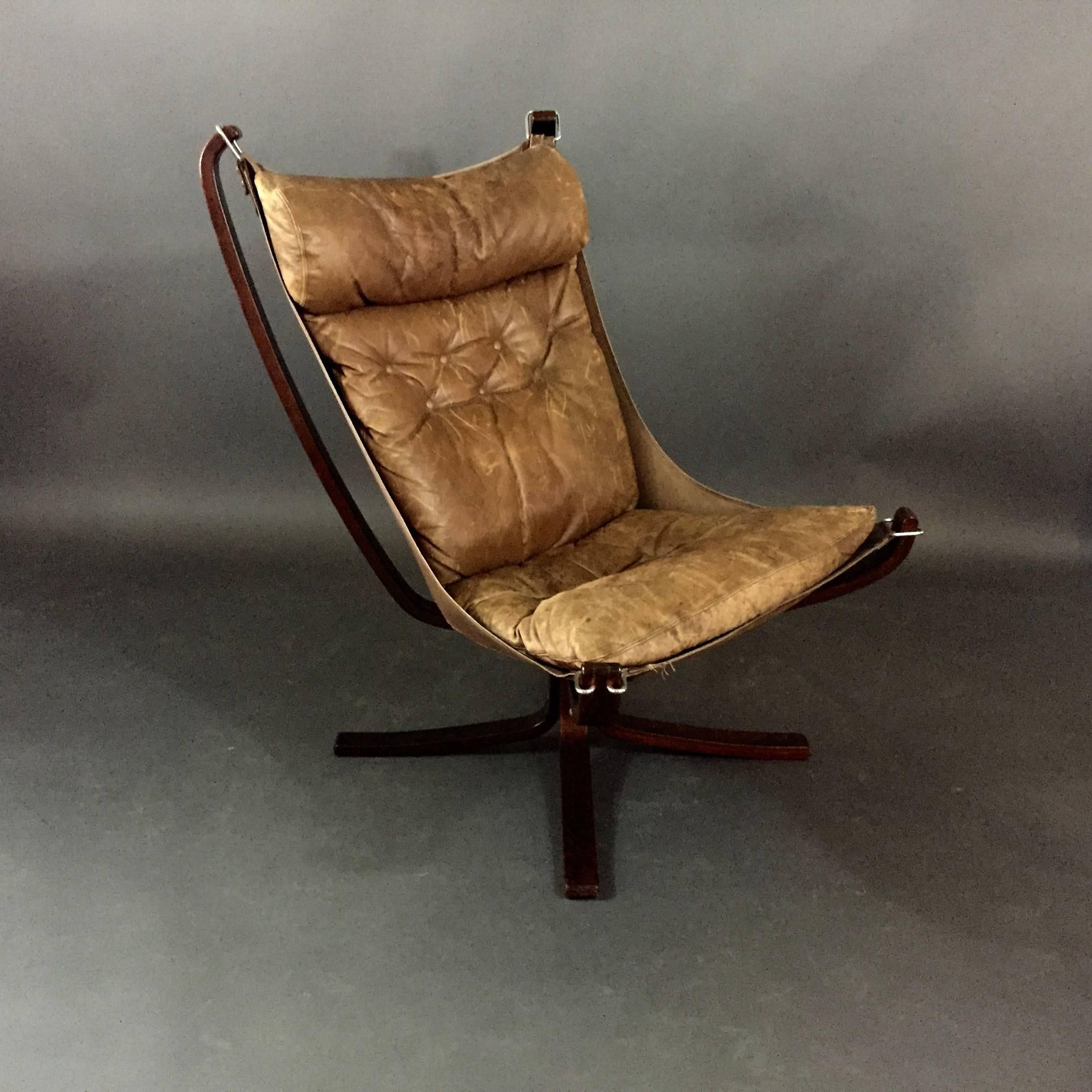 Easily his most famous iconic design, Norwegian Sigurd Ressell created this chair and series of like furniture in 1971 and manufactured by Vatne Møbler in Norway. This lightweight tall-back Falcon has perfect patina cognac leather seating and is
