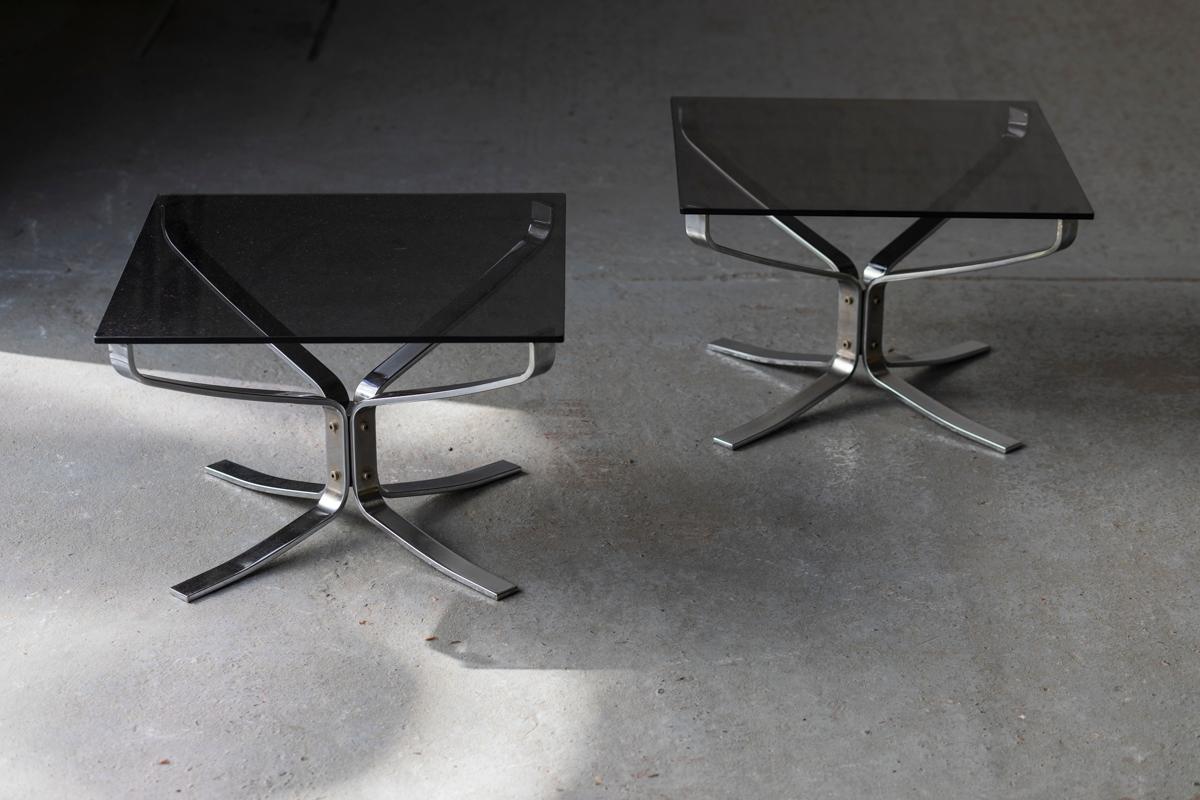 Set of 2 chrome side tables with a smoked glass top designed by Sigurd Ressell and produced by Vatne Mobler in Norway during the 1960’s. Few using marks as shown in the pictures. In very good condition. We sell them separately too. 

H: 40 cm
W: 59
