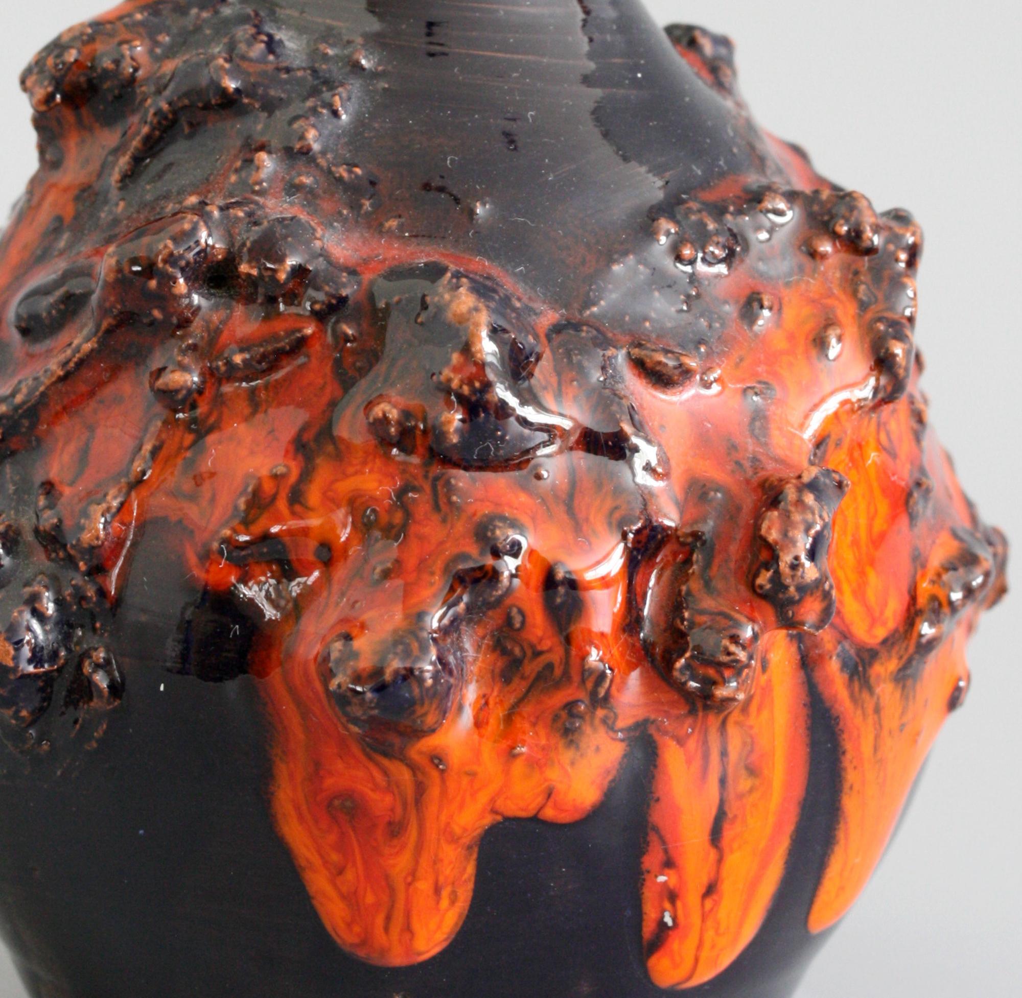 A very striking Icelandic art pottery vase decorated in lava glazes by Sigurður Hákon Arnórsson made in the 1970s. The vase, Brutalist in style, is of rounded shape with a narrow slender neck and is applied with real lava collected from the rim of