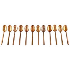 Sigvard Bernadotte 'Scanline' Cutlery in Brass, Set of Twelve Spoons