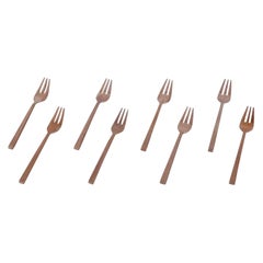 Sigvard Bernadotte 'Scanline' cutlery set in brass. Eight cake forks.