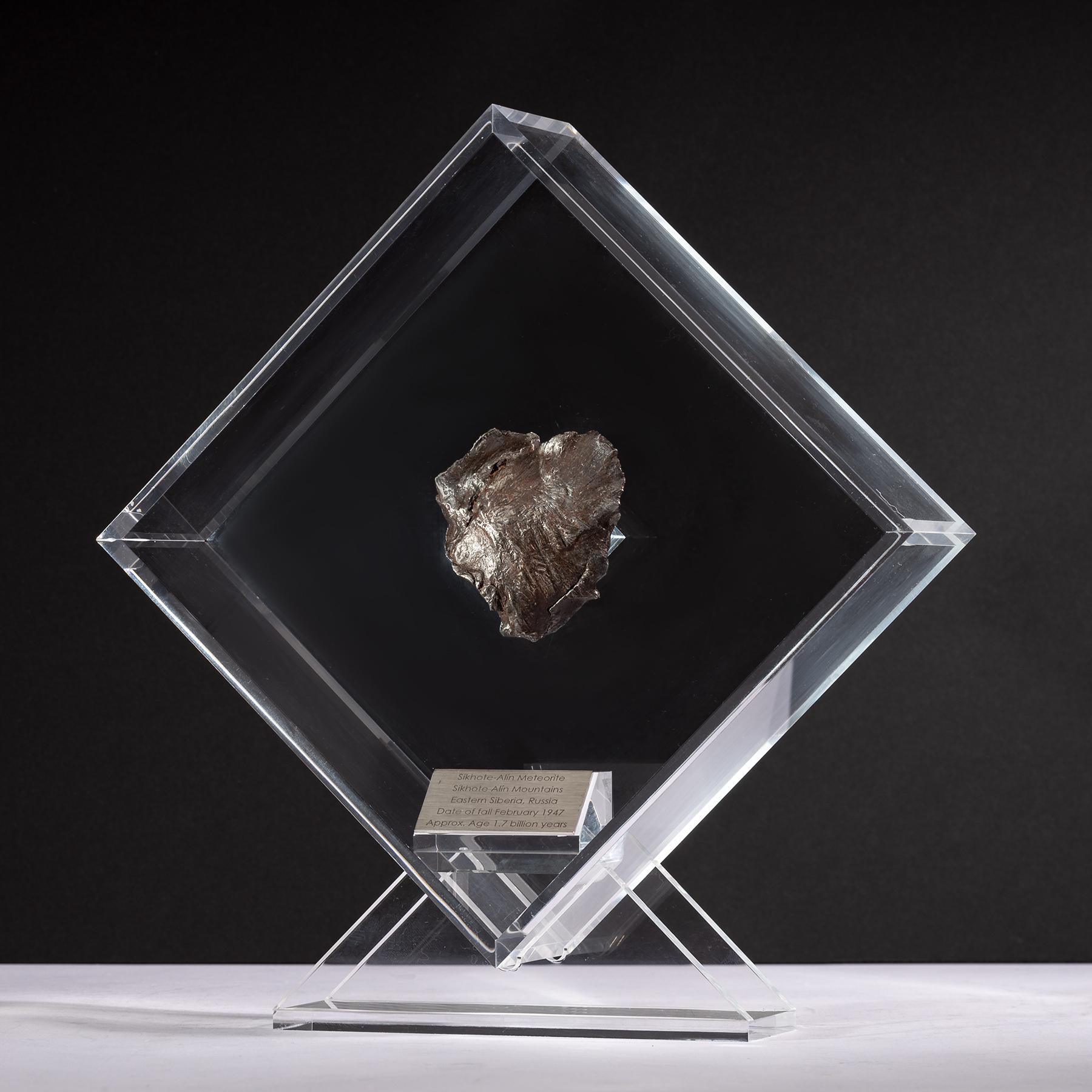 Original design in Acrylic display with a magnet making the meteorite look as it´s floating the same way it did in outer space for years before its final visit to Earth. 

Sikhote Alin Meteorite
This iron meteorite fell in Eastern Siberia, Russia