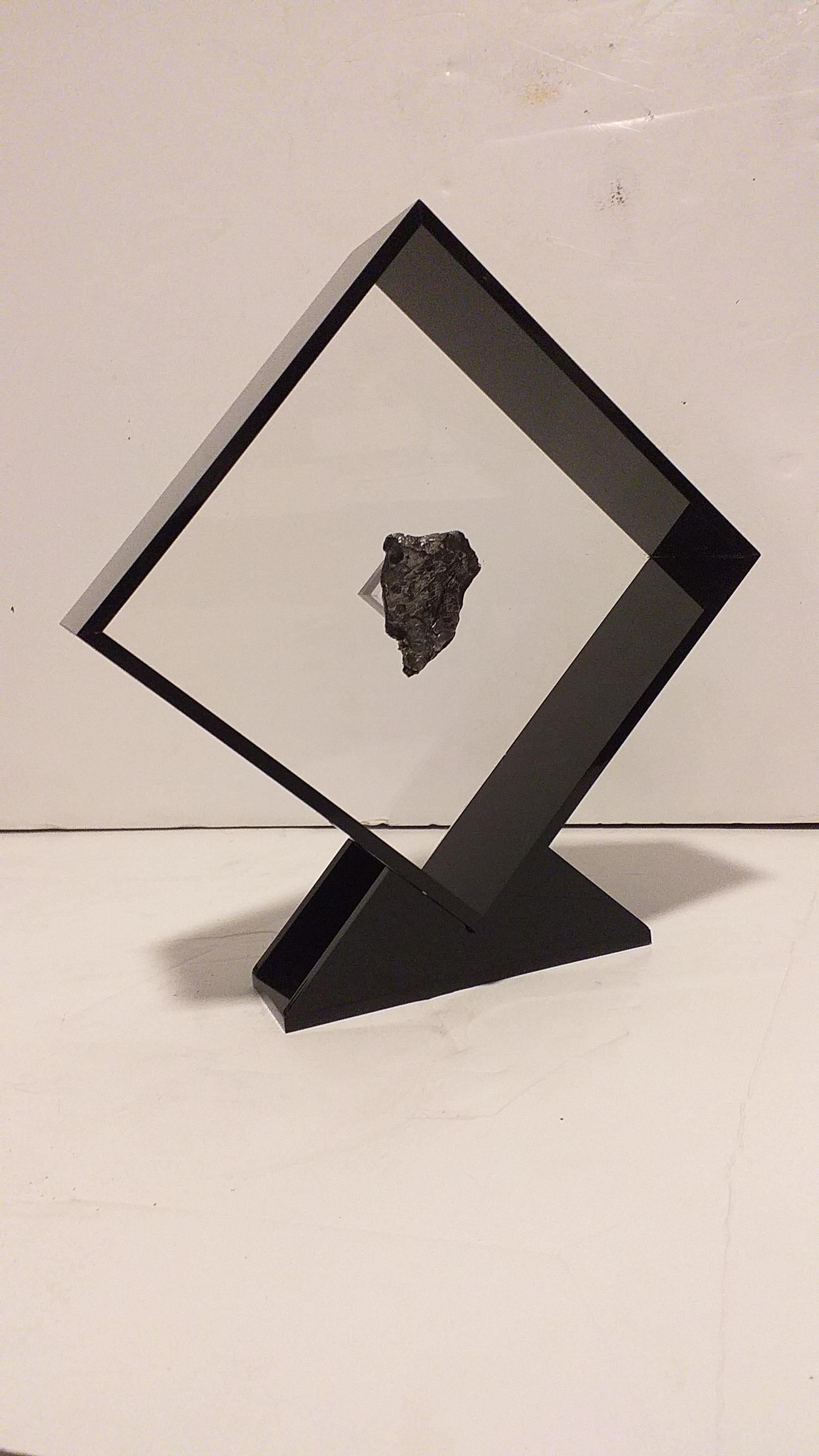 Original design in acrylic display with a magnet making the Meteorite look as it´s floating the same way it did in outer space for years before its final visit to Earth. 

Sikhote Alin Meteorite
This iron Meteorite fell in Eastern Siberia, Russia on