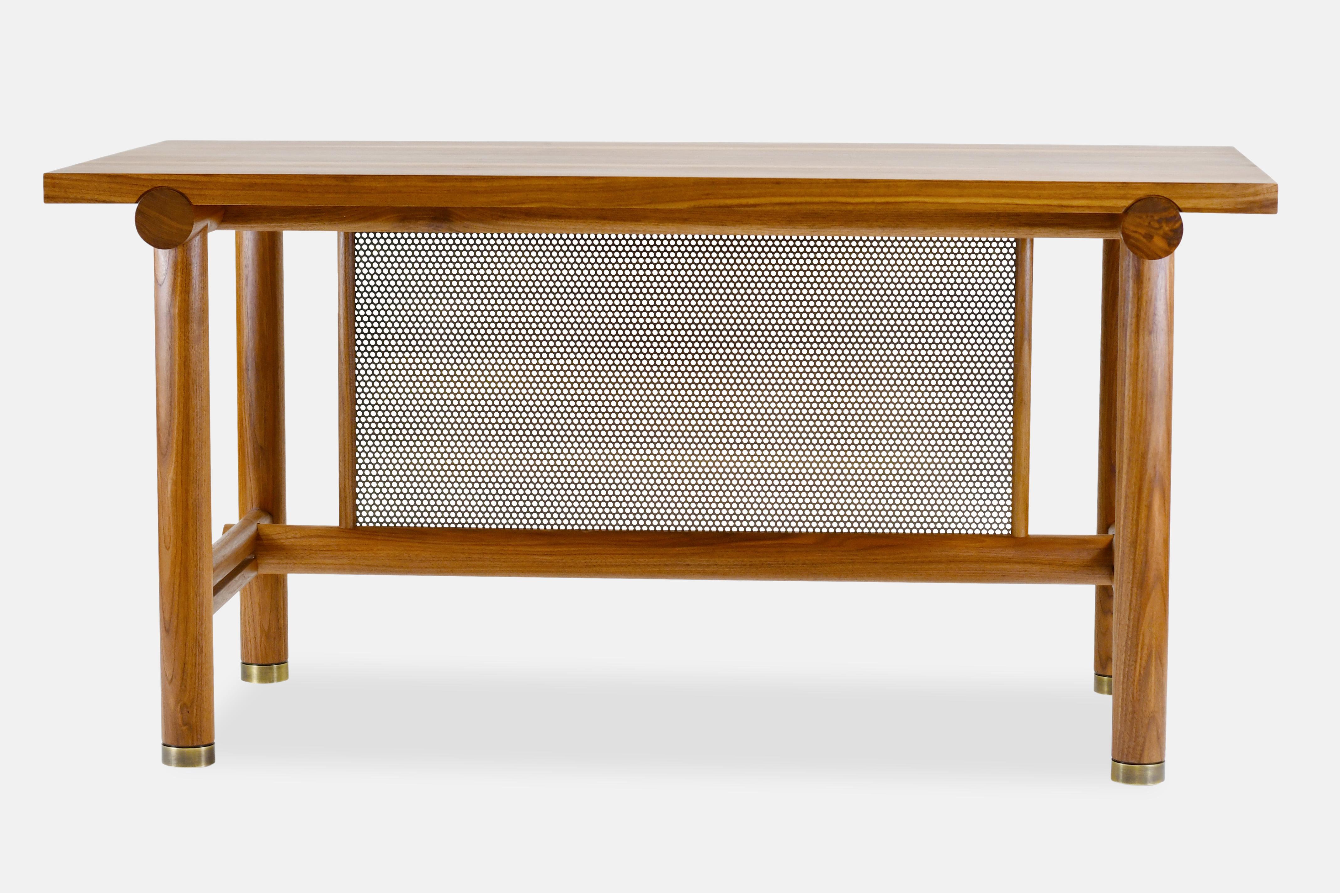 The Silas Desk is crafted in solid hardwood with steel and brass accents. Inspired by the classic work bench, this desk focuses on a work surface from a simpler time. 

Handcrafted with interlocking round posts, a perforated modesty panel and plated