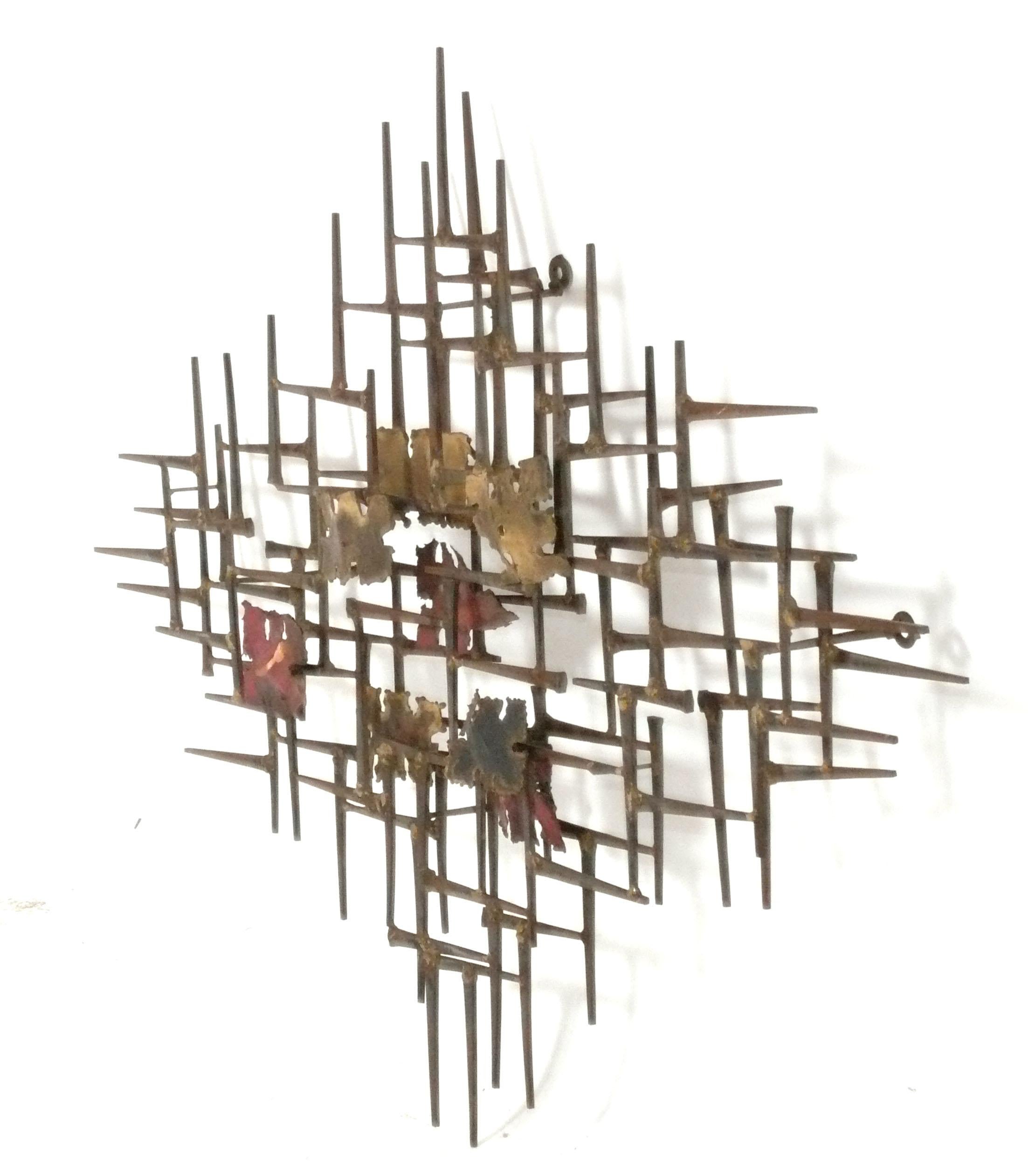 Abstract Metal Wall Sculpture, by Silas Seandel, American, circa 1970s. Signed on back side. It measures an impressive 33.5