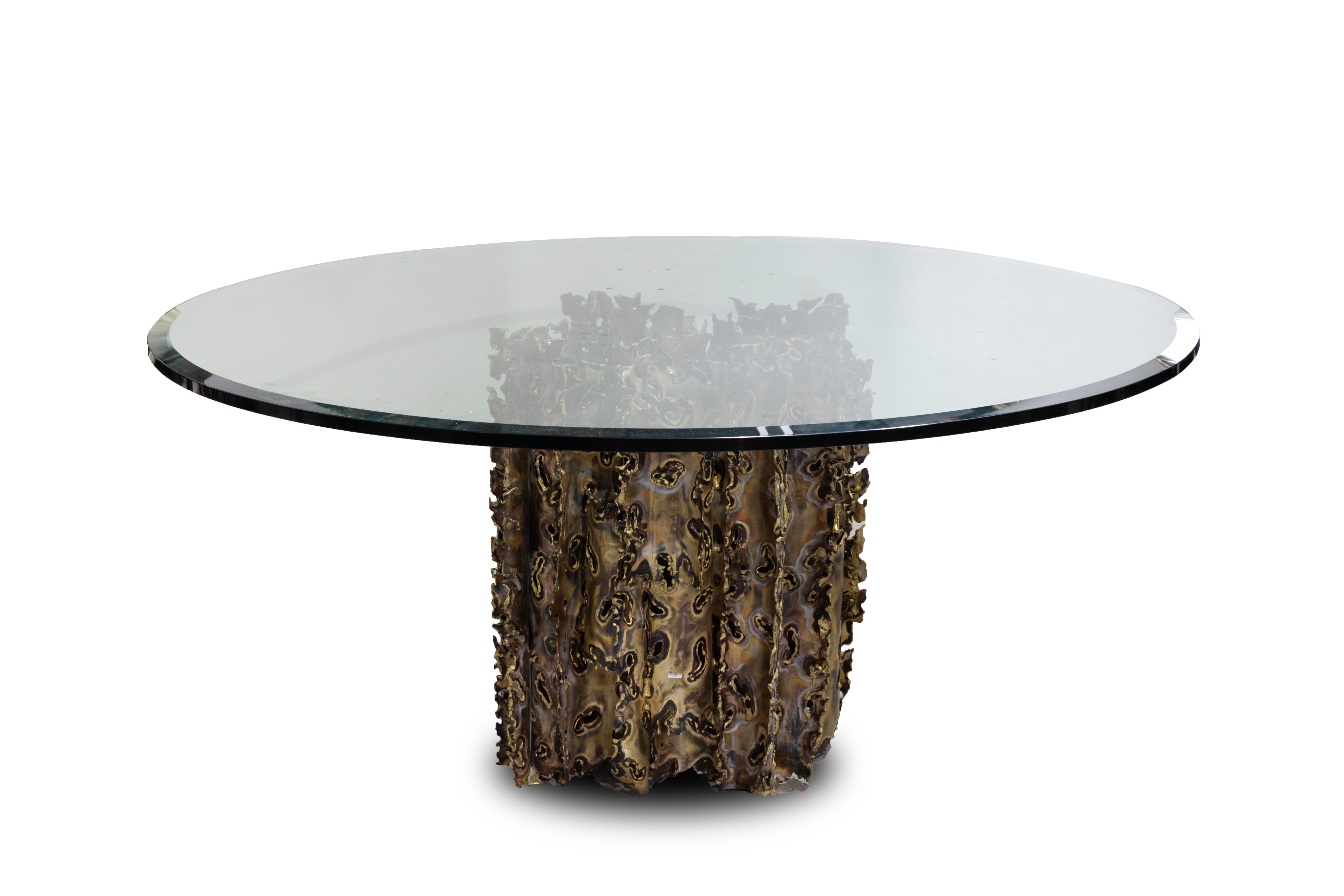 Silas Seandel - Cathedral series dining table. A Mid-Century Modern Brutalist style dining table by Silas Seandel with a clear, round beveled glass top and handcut, welded and acid etched bronze base, USA, 1970s. Approx 25