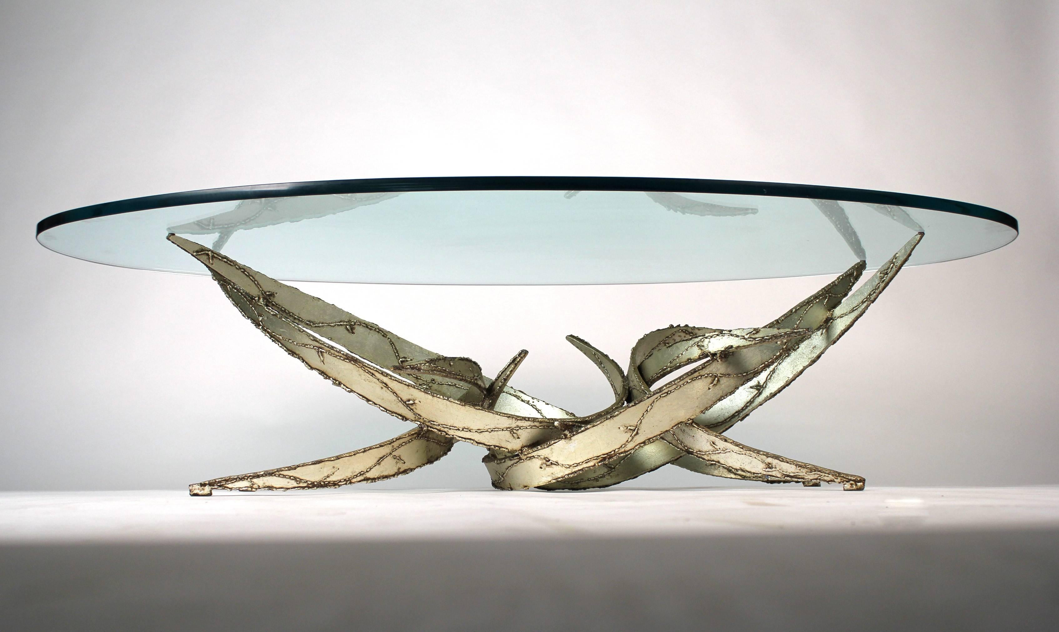 Silver leafed torch cut coffee table by Silas Seandel. Retains original glass top. 

Base measures: 44 x 21