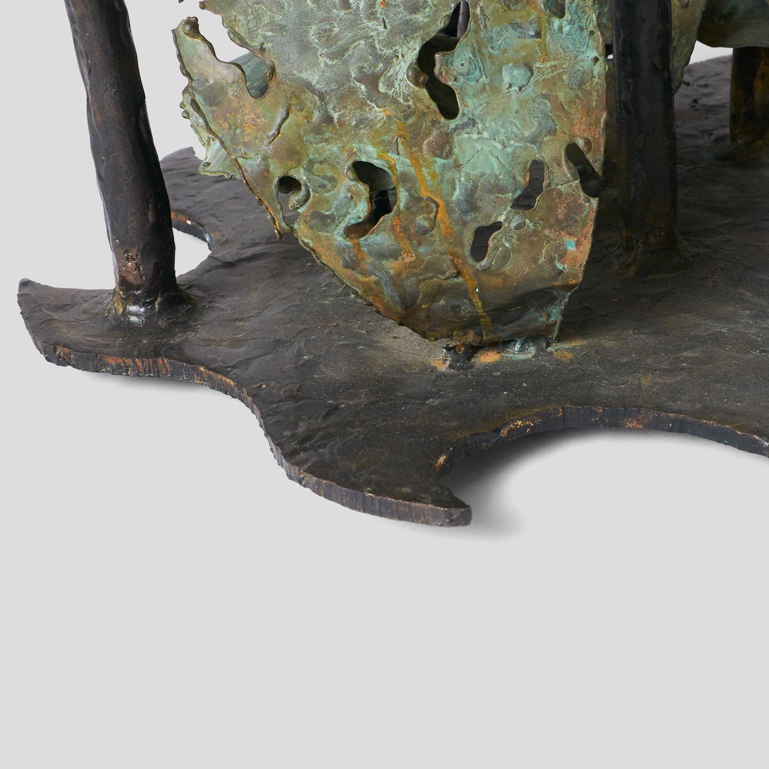 A brutalist woodland coffee table by Silas Seandel. Enameled bronze mushrooms and bronze sprouts support glass square top.
  

Chips on the glass corners.