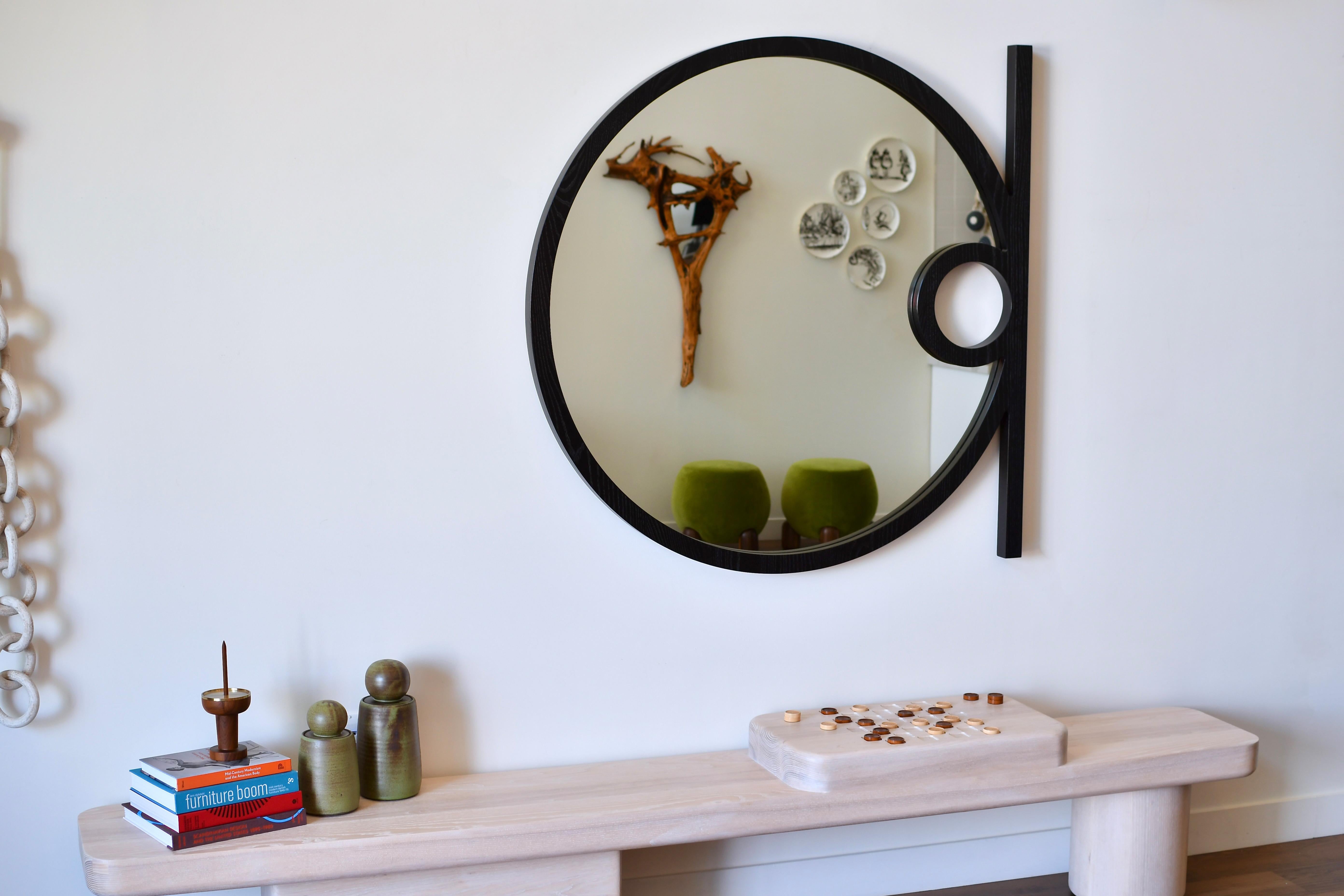 The Silas Wall Mirror is an elegant, minimalist form, inspired by the playful use of shape and geometry throughout the Mid-Century Modern Movement.  The handcrafted warmth of the solid wood frame along with creative use of negative space and linear