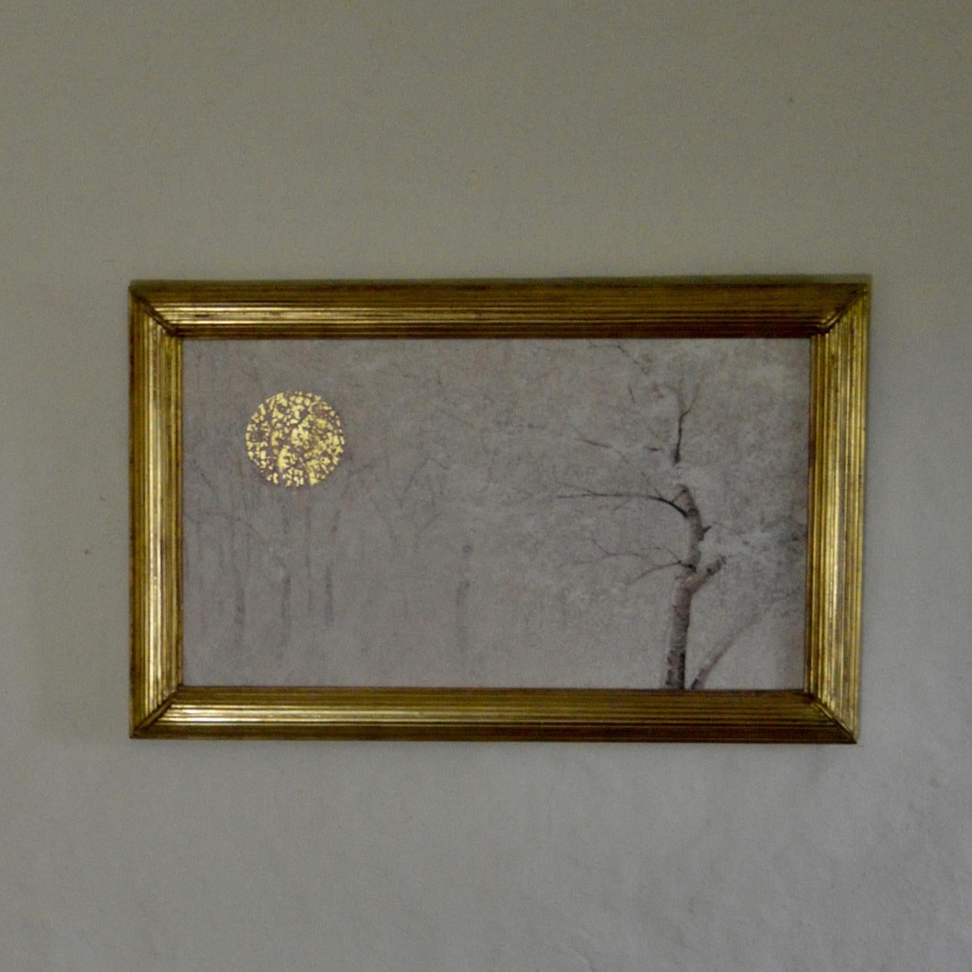 This delightful oil painting on a wooden panel depicts a quiet landscape covered in a mantle of pristine snow. The reflective power of the gold leaf is showcased un the moon/sun, whose light filters through the tree branches and mixes with the dewy