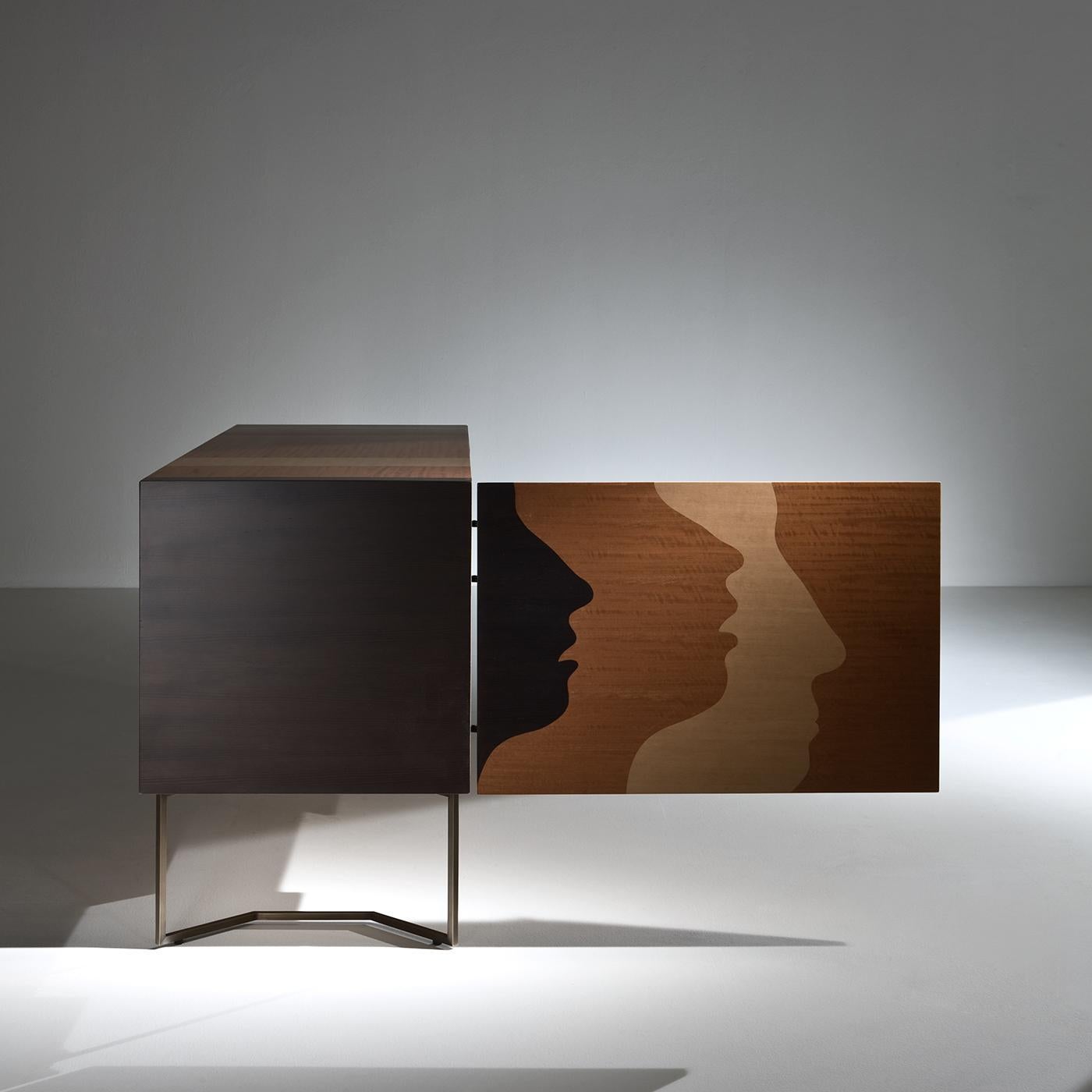 This extraordinary wooden sideboard is an exclusive piece of exquisite craftsmanship, part of a limited series of only 21 specimens. The inlaid pattern on the surface uses different shades of wood to create a 3D arrangement of silhouettes. The two