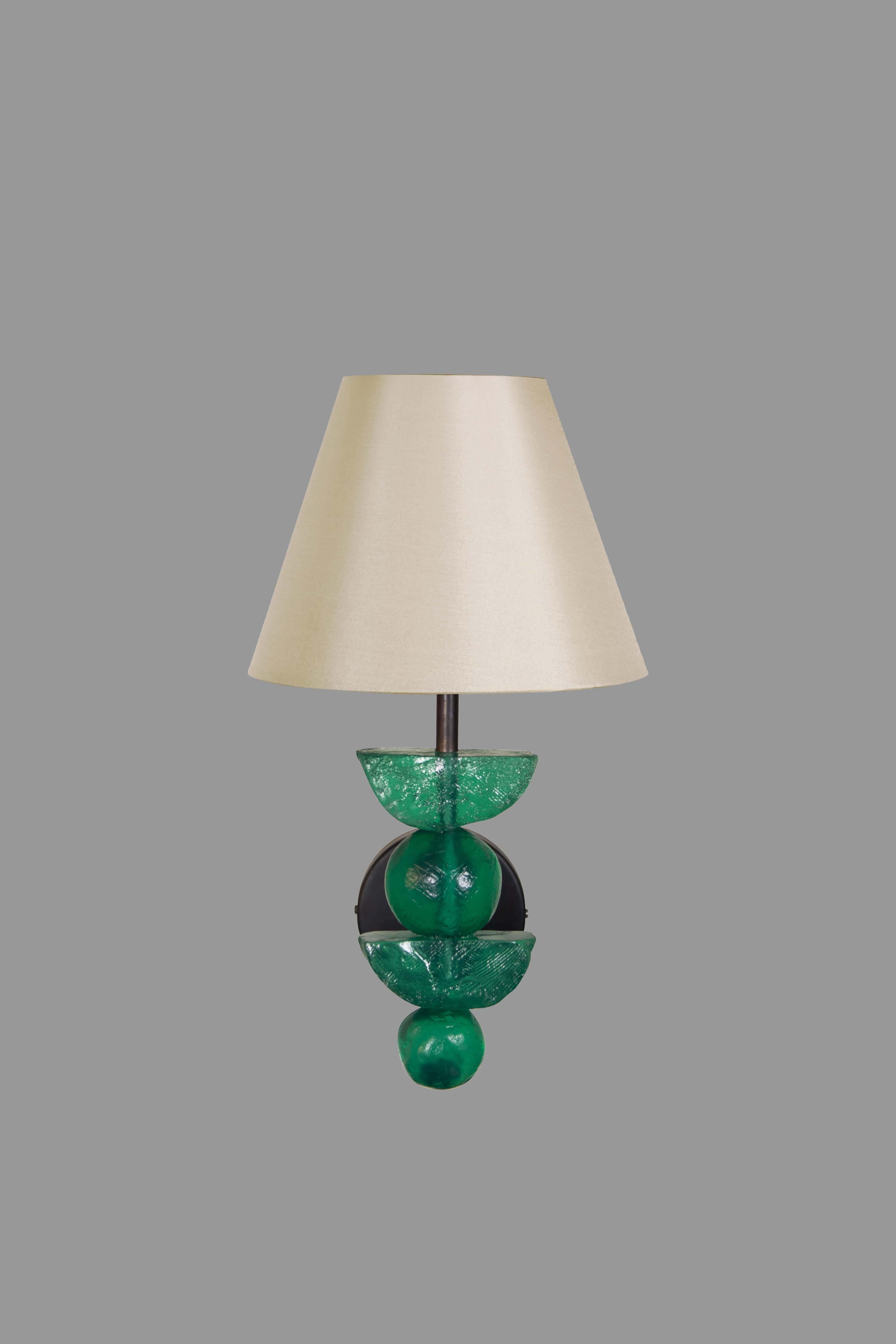 This Margit Wittig wall light with emerald resin hand-sculpted components is cast in her London-based studio.
The hand-patinated gold finish enhances the organic surface texture, a brass detail adds interest to this object of art which provides a