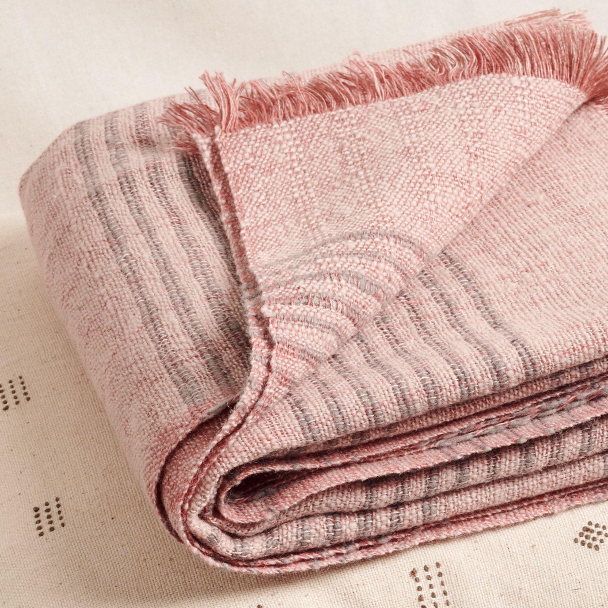 Silica Rose Throw is a modern take on combining stripes  & checks pattern in a serene color palette of dusty rose salmon and grays. Fine detail of hand weaving is done meticulously on a handwoven textile. Each piece is 100% handmade making it a