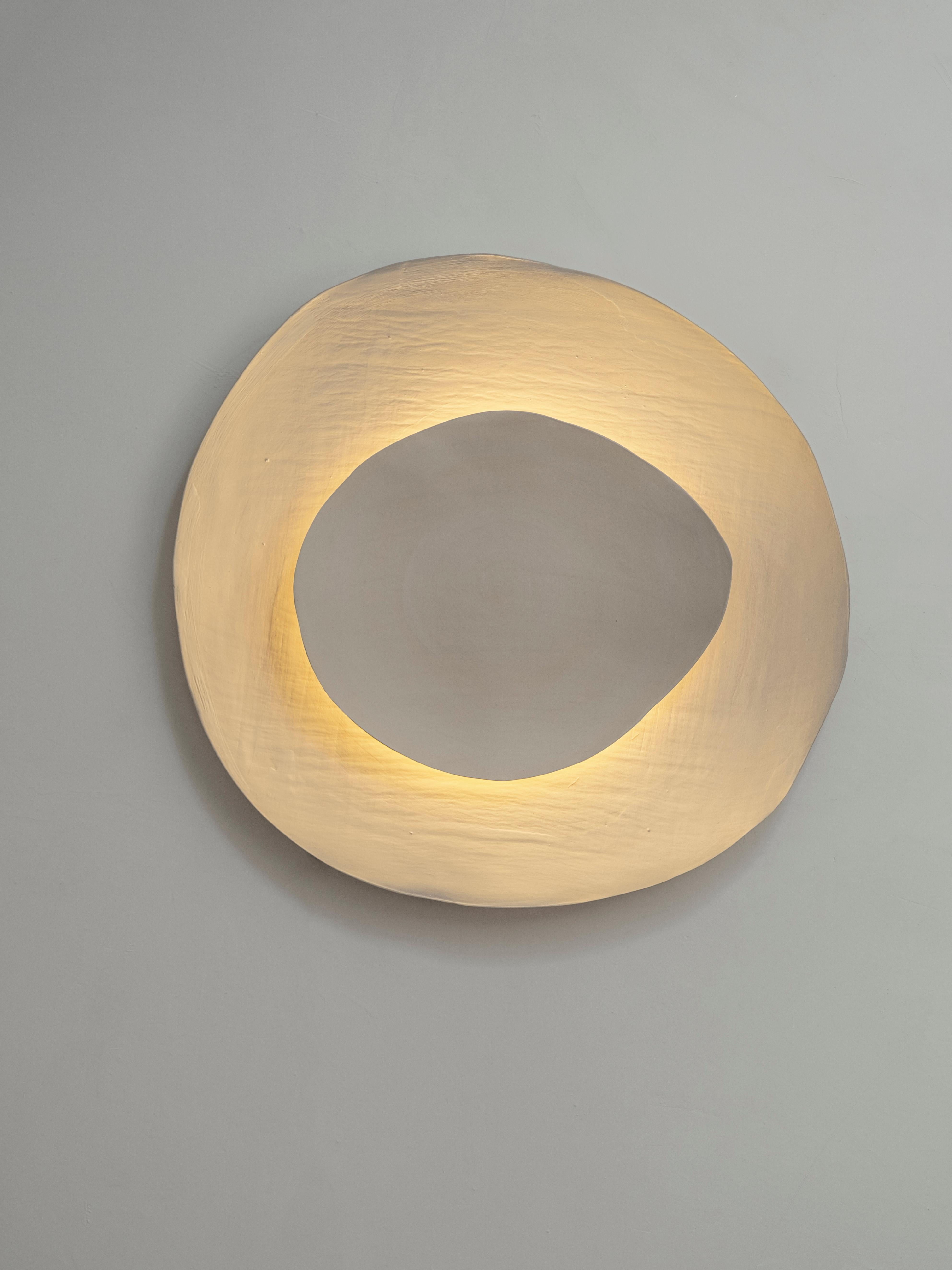 Silk #13 wall light by Margaux Leycuras
One of a Kind, Signed and numbered
Dimensions: Ø52, H55 cm.
Material: Ceramic, sandy stoneware platters with a porcelain slip finish.
The piece is signed, numbered and delivered with a certificate of